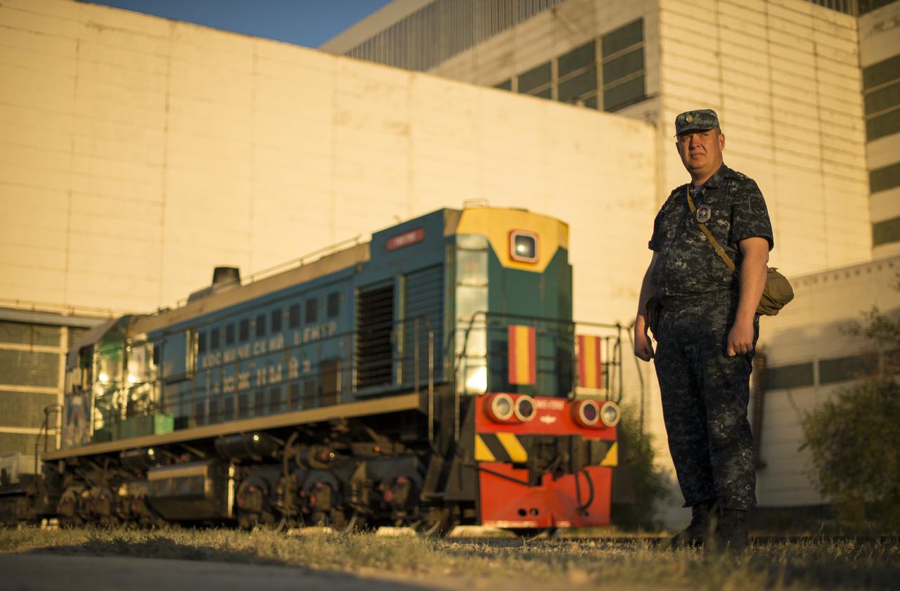 A policeman stands by and awaits the rollout of the Soyuz TMA-09M spacecraft by train to the Baikonur Cosmodrome launch pad, Sunday, May 26, 2013, in Kazakhstan. The launch of the Soyuz rocket to the International Space Station (ISS) with Expedition 36/37 Soyuz Commander Fyodor Yurchikhin of the Russian Federal Space Agency (Roscosmos), Flight Engineers; Luca Parmitano of the European Space Agency, and Karen Nyberg of NASA, is scheduled for Wednesday May 29, Kazakh time. Yurchikhin, Nyberg, and, Parmitano, will remain aboard the station until mid-November. Photo credit: (NASA/Bill Ingalls)