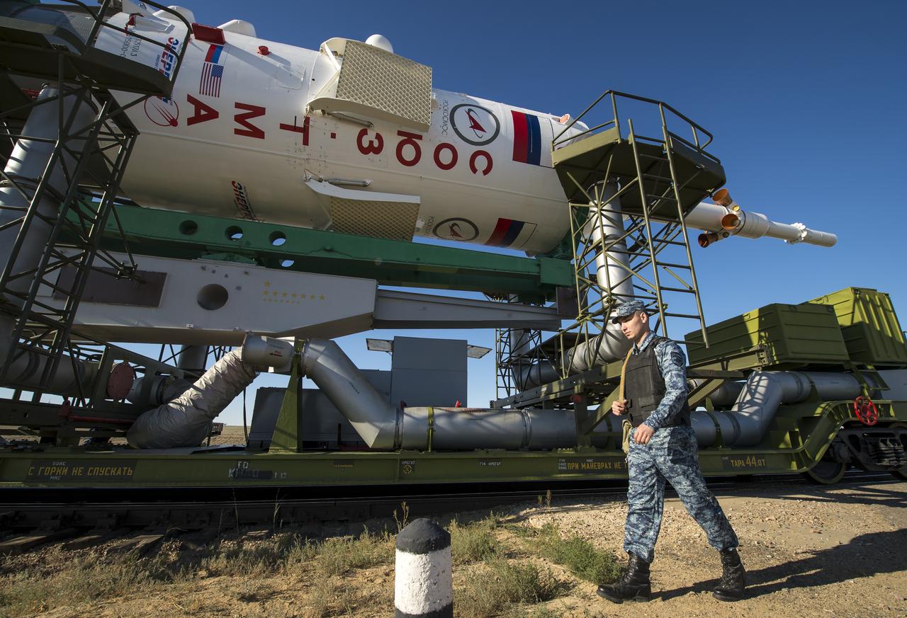 A policeman walks along the Soyuz TMA-09M spacecraft as it is rolled out by train to the Baikonur Cosmodrome launch pad, Sunday, May 26, 2013, in Kazakhstan.  The launch of the Soyuz rocket to the International Space Station (ISS) with Expedition 36/37 Soyuz Commander Fyodor Yurchikhin of the Russian Federal Space Agency (Roscosmos), Flight Engineers; Luca Parmitano of the European Space Agency, and Karen Nyberg of NASA, is scheduled for Wednesday May 29, Kazakh time. Yurchikhin, Nyberg, and, Parmitano, will remain aboard the station until mid-November. Photo credit: (NASA/Bill Ingalls)