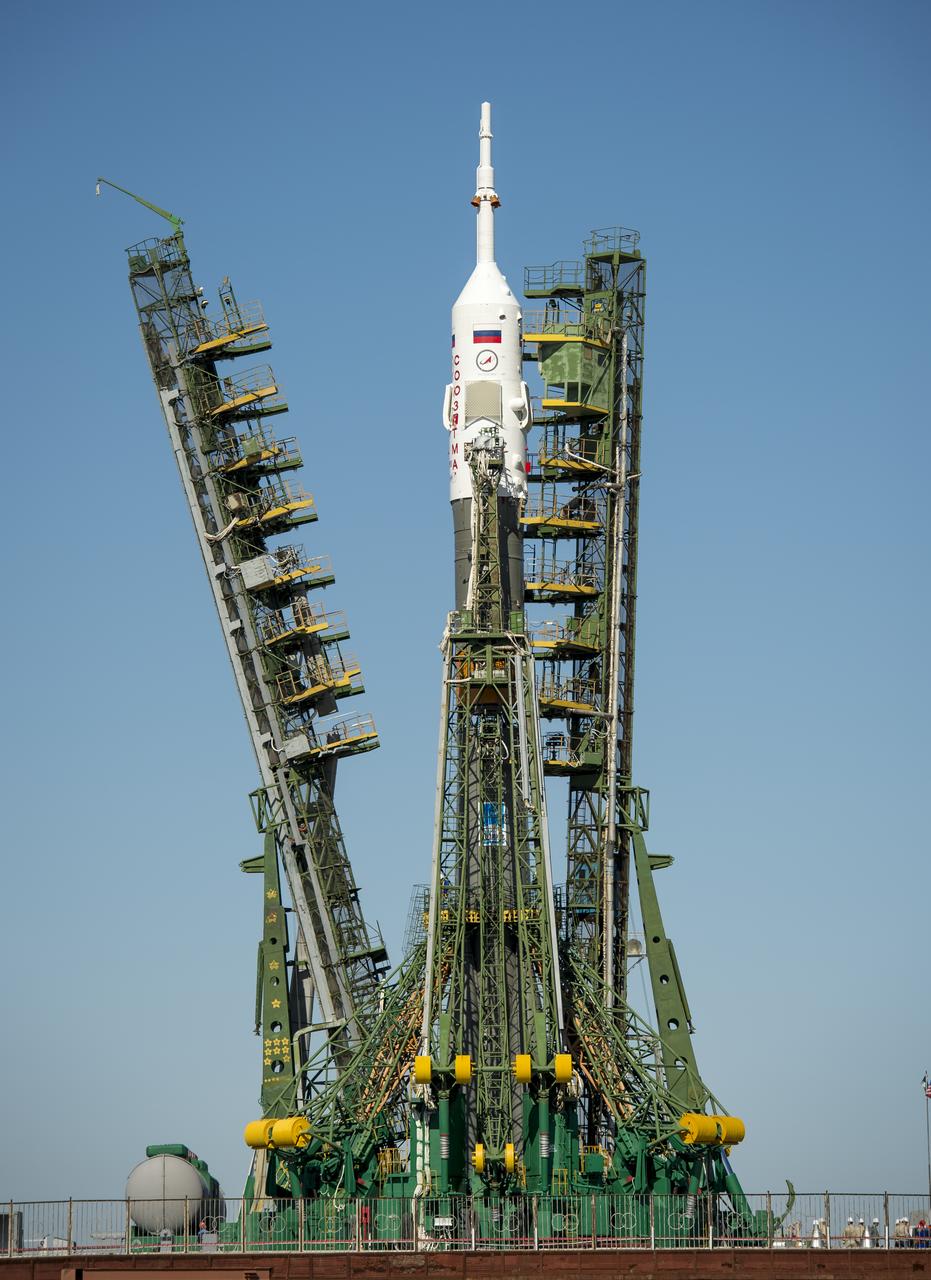 The Service arms are raised into position around the Soyuz rocket, with the TMA-09M spacecraft, after arriving at the Baikonur Cosmodrome launch pad by train, Sunday, May 26, 2013, in Kazakhstan.  The launch of the Soyuz rocket to the International Space Station (ISS) with Expedition 36/37 Soyuz Commander Fyodor Yurchikhin of the Russian Federal Space Agency (Roscosmos), Flight Engineers; Luca Parmitano of the European Space Agency, and Karen Nyberg of NASA, is scheduled for Wednesday May 29, Kazakh time. Yurchikhin, Nyberg, and, Parmitano, will remain aboard the station until mid-November. Photo credit: (NASA/Bill Ingalls)