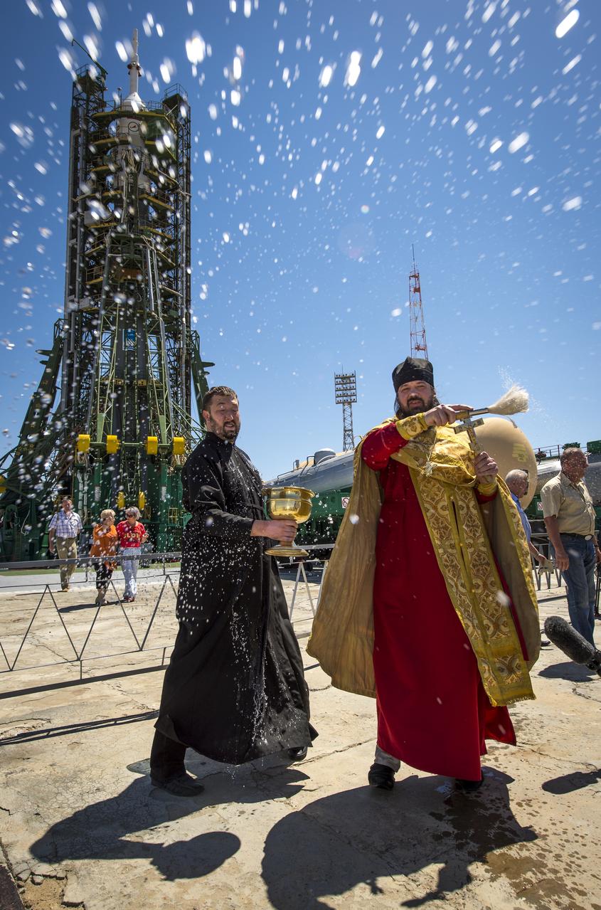 An Orthodox Priest blesses members of the media shortly after having blessed the Soyuz rocket at the Baikonur Cosmodrome Launch pad on Monday, May 27, 2013 in Kazakhstan.  The launch of the Soyuz rocket to the International Space Station (ISS) with Expedition 36/37 Soyuz Commander Fyodor Yurchikhin of the Russian Federal Space Agency (Roscosmos), Flight Engineers; Luca Parmitano of the European Space Agency, and Karen Nyberg of NASA, is scheduled for Wednesday May 29, Kazakh time. Yurchikhin, Nyberg, and, Parmitano, will remain aboard the station until mid-November. Photo credit: (NASA/Bill Ingalls)