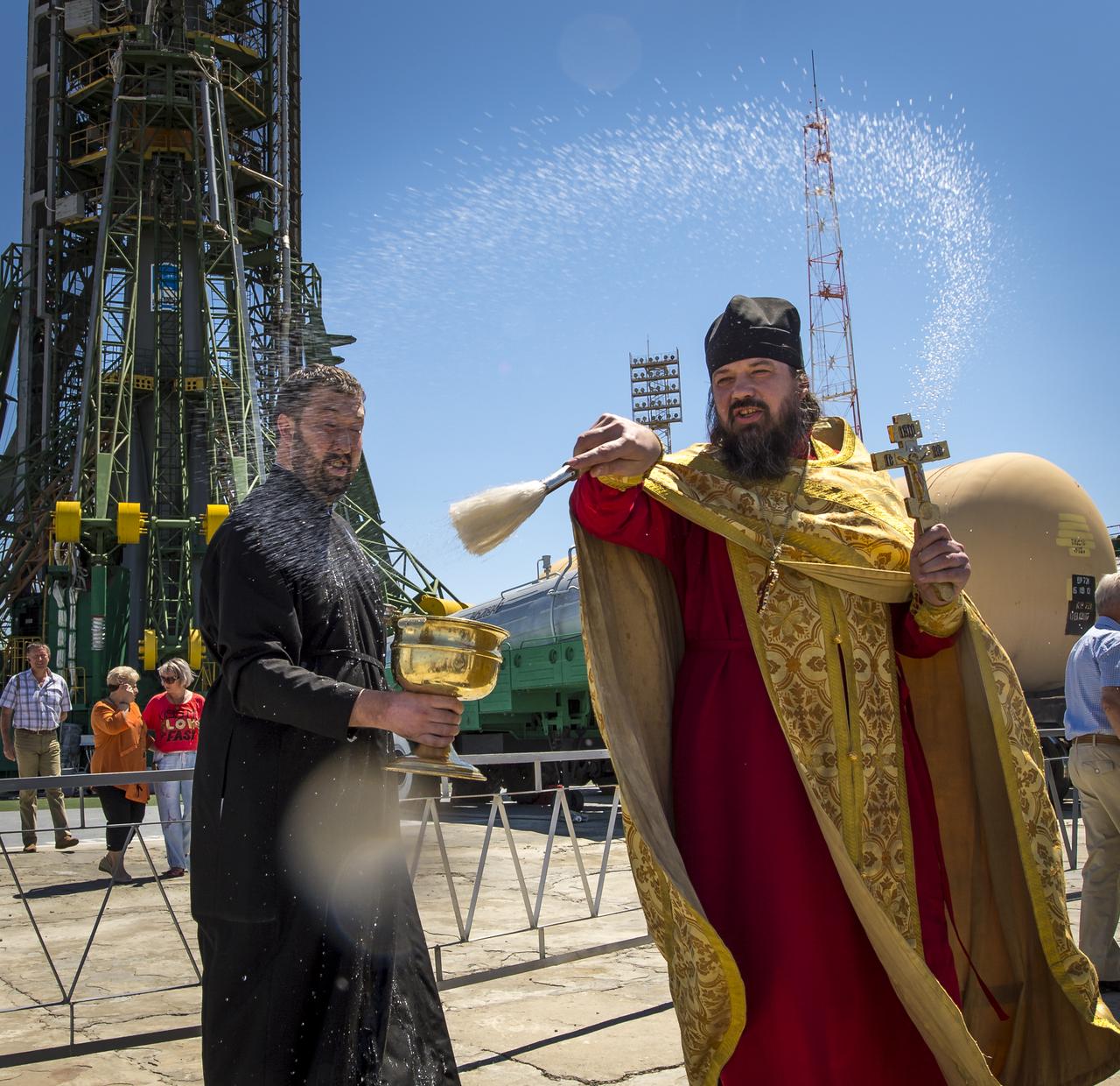 An Orthodox Priest blesses members of the media shortly after having blessed the Soyuz rocket at the Baikonur Cosmodrome Launch pad on Monday, May 27, 2013 in Kazakhstan.  The launch of the Soyuz rocket to the International Space Station (ISS) with Expedition 36/37 Soyuz Commander Fyodor Yurchikhin of the Russian Federal Space Agency (Roscosmos), Flight Engineers; Luca Parmitano of the European Space Agency, and Karen Nyberg of NASA, is scheduled for Wednesday May 29, Kazakh time. Yurchikhin, Nyberg, and, Parmitano, will remain aboard the station until mid-November. Photo credit: (NASA/Bill Ingalls)