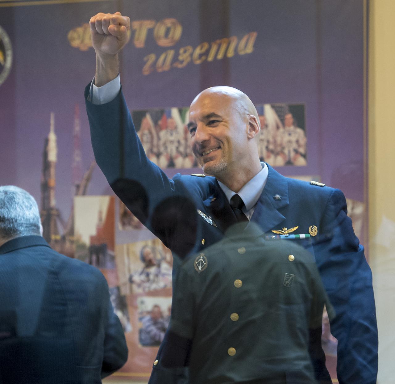 Expedition 36/37 Flight Engineer Luca Parmitano of the European Space Agency gets the attention of a colleague after the State Commission meeting at the Cosmonaut Hotel, Monday, May 27, 2013, in Kazakhstan. Parmitano and his fellow crew members, Soyuz Commander Fyodor Yurchikhin of the Russian Federal Space Agency (Roscosmos), and Flight Engineer Karen Nyberg of NASA, were in quarantine and kept behind glass during the meeting in preparation for their launch on a Soyuz rocket to the International Space Station (ISS) on Wednesday May 29, Kazakh time. Photo credit: (NASA/Bill Ingalls)