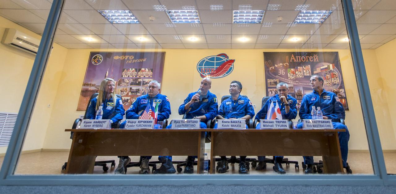 From left, Expedition 36/37 Flight Engineer Karen Nyberg of NASA, Soyuz Commander Fyodor Yurchikhin of the Russian Federal Space Agency (Roscosmos), Flight Engineer Luca Parmitano of the European Space Agency, and Expedition 36/37 backup crew members; Koichi Wakata of the Japan Aerospace Exploration Agency, Mikhail Tyurin of the Russian Federal Space Agency (Roscosmos), and Rick Mastracchio of NASA are seen during the crew's press conference at the Cosmonaut Hotel, Monday, May 27, 2013, in Kazakhstan. The crew is in quarantine and behind glass during the press conference in preparation for their launch on a Soyuz rocket to the International Space Station (ISS) on Wednesday May 29, Kazakh time. Yurchikhin, Nyberg, and, Parmitano, will remain aboard the station until mid-November. Photo credit: (NASA/Bill Ingalls)