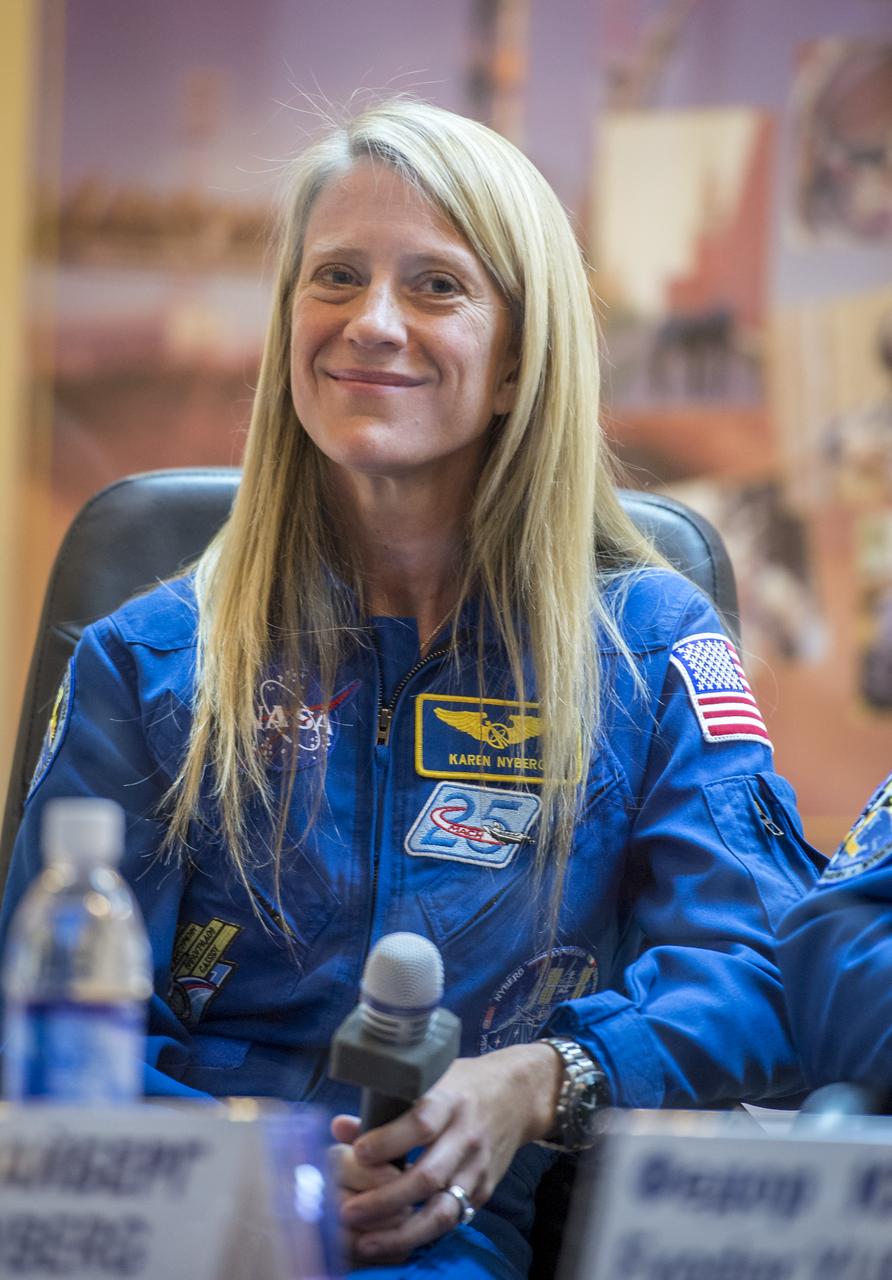 Expedition 36/37 Flight Engineer Karen Nyberg of NASA smiles during the crew press conference at the Cosmonaut Hotel, Monday, May 27, 2013, in Kazakhstan. Nyberg and her fellow crew members, Soyuz Commander Fyodor Yurchikhin of the Russian Federal Space Agency (Roscosmos), and Flight Engineer Luca Parmitano of the European Space Agency, were in quarantine and kept behind glass during the press conference in preparation for their launch on a Soyuz rocket to the International Space Station (ISS) on Wednesday May 29, Kazakh time. Photo credit: (NASA/Bill Ingalls)