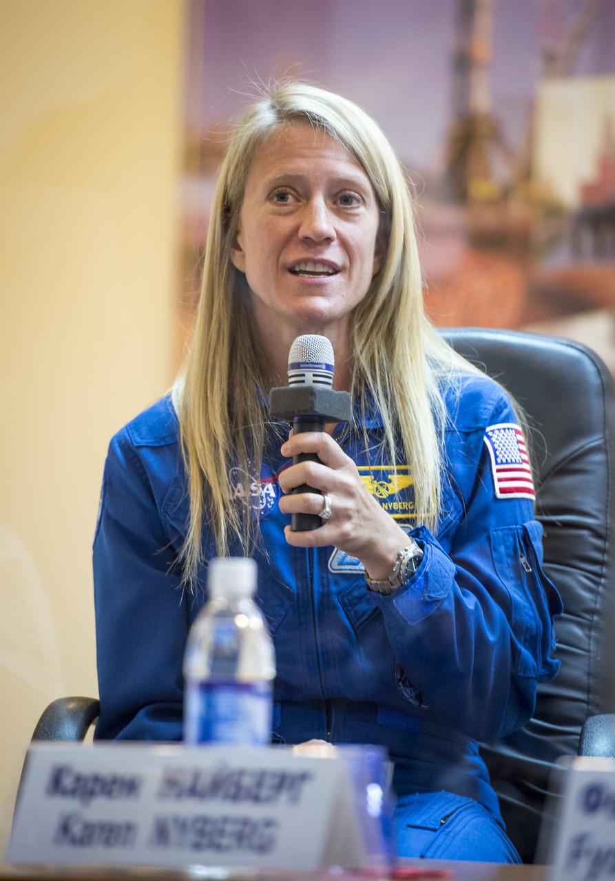 Expedition 36/37 Flight Engineer Karen Nyberg of NASA talks during the crew press conference at the Cosmonaut Hotel, Monday, May 27, 2013, in Kazakhstan. Nyberg and her fellow crew members, Soyuz Commander Fyodor Yurchikhin of the Russian Federal Space Agency (Roscosmos), and Flight Engineer Luca Parmitano of the European Space Agency, were in quarantine and kept behind glass during the press conference in preparation for their launch on a Soyuz rocket to the International Space Station (ISS) on Wednesday May 29, Kazakh time. Photo credit: (NASA/Bill Ingalls)