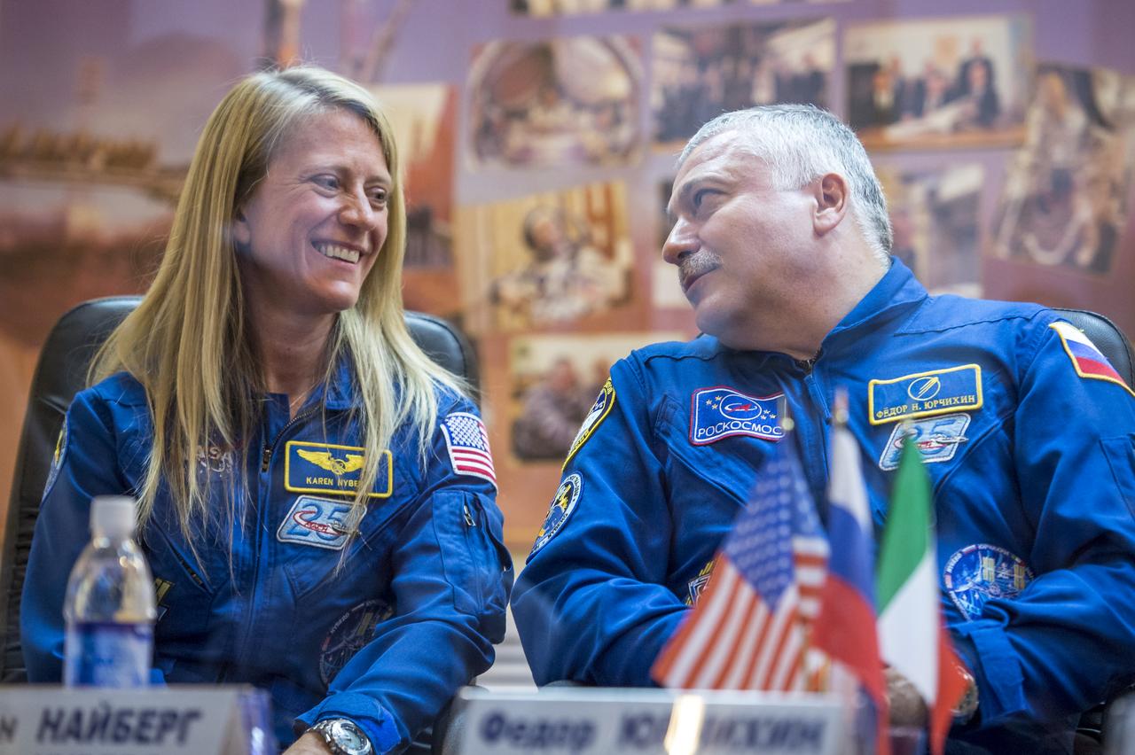 Expedition 36/37 Soyuz Commander Fyodor Yurchikhin of the Russian Federal Space Agency (Roscosmos) and Flight Engineer Karen Nyberg of NASA, are seen during the crew press conference at the Cosmonaut Hotel, Monday, May 27, 2013, in Kazakhstan. Yurchikhin, Nyberg and fellow crew member Luca Parmitano of the European Space Agency, were in quarantine and kept behind glass during the press conference in preparation for their launch on a Soyuz rocket to the International Space Station (ISS) on Wednesday May 29, Kazakh time. Photo credit: (NASA/Bill Ingalls)