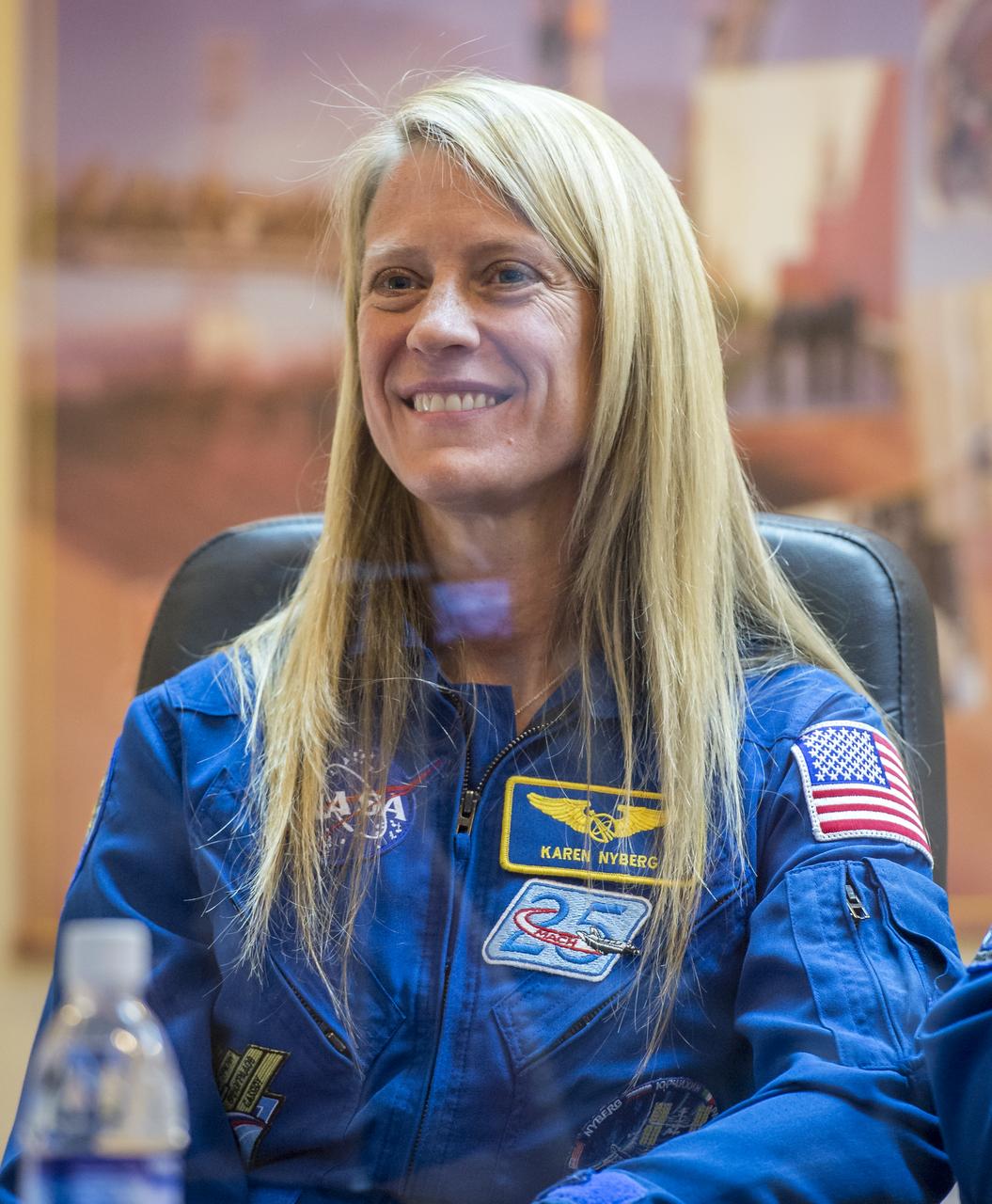 Expedition 36/37 Flight Engineer Karen Nyberg of NASA smiles during the crew press conference at the Cosmonaut Hotel, Monday, May 27, 2013, in Kazakhstan. Nyberg and her fellow crew members, Soyuz Commander Fyodor Yurchikhin of the Russian Federal Space Agency (Roscosmos), and Flight Engineer Luca Parmitano of the European Space Agency, were in quarantine and kept behind glass during the press conference in preparation for their launch on a Soyuz rocket to the International Space Station (ISS) on Wednesday May 29, Kazakh time. Photo credit: (NASA/Bill Ingalls)