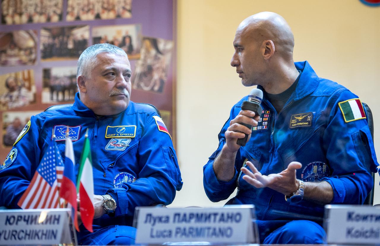 Expedition 36/37 Flight Engineer Luca Parmitano of the European Space Agency, right, and Soyuz Commander Fyodor Yurchikhin of the Russian Federal Space Agency (Roscosmos) are seen during the crew press conference at the Cosmonaut Hotel, Monday, May 27, 2013, in Kazakhstan. Parmitano, Yurchikhin and fellow crew member Karen Nyberg of NASA, were in quarantine and kept behind glass during the press conference in preparation for their launch on a Soyuz rocket to the International Space Station (ISS) on Wednesday May 29, Kazakh time. Photo credit: (NASA/Bill Ingalls)