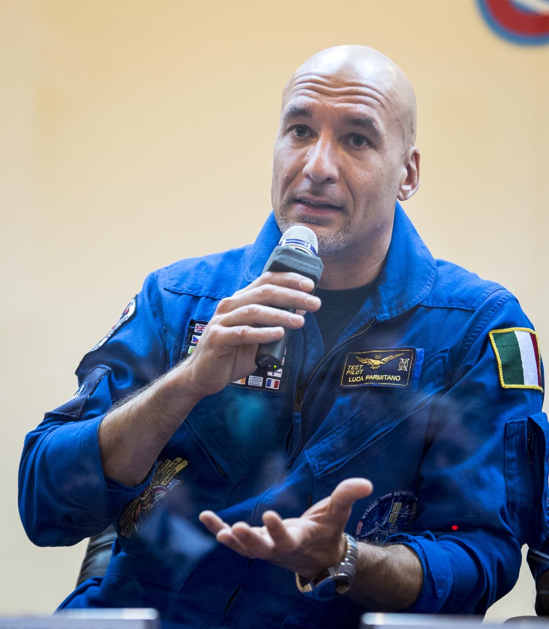 Expedition 36/37 Flight Engineer Luca Parmitano of the European Space Agency talks during the crew press conference at the Cosmonaut Hotel, Monday, May 27, 2013, in Kazakhstan. Parmitano and his fellow crew members, Soyuz Commander Fyodor Yurchikhin of the Russian Federal Space Agency (Roscosmos), and Flight Engineer Karen Nyberg of NASA, were in quarantine and kept behind glass during the press conference in preparation for their launch on a Soyuz rocket to the International Space Station (ISS) on Wednesday May 29, Kazakh time. Photo credit: (NASA/Bill Ingalls)