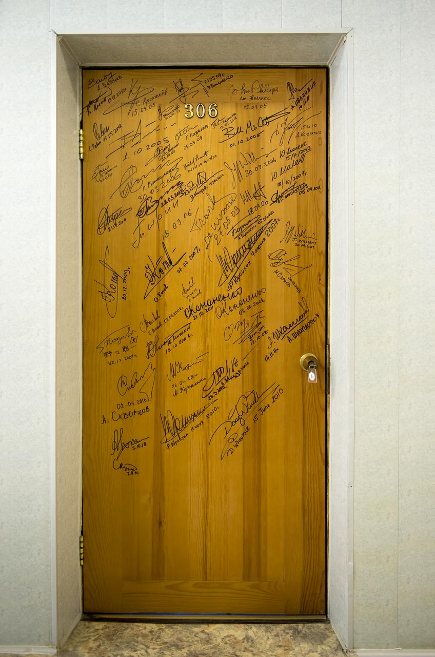 A hotel room door covered with signatures of Astronauts and Cosmonauts is seen at the Cosmonaut Hotel, Tuesday, May 28, 2013 in Baikonur, Kazakhstan.  Expedition 36/37 Soyuz Commander Fyodor Yurchikhin of the Russian Federal Space Agency (Roscosmos), Flight Engineers: Flight Engineer Karen Nyberg of NASA, and, Luca Parmitano of the European Space Agency each signed doors in the traditional ceremony prior to departing the hotel for launch onboard a Soyuz to the International Space Station. Yurchikhin, Nyberg, and, Parmitano, will remain aboard the station until mid-November. Photo credit: (NASA/Bill Ingalls)