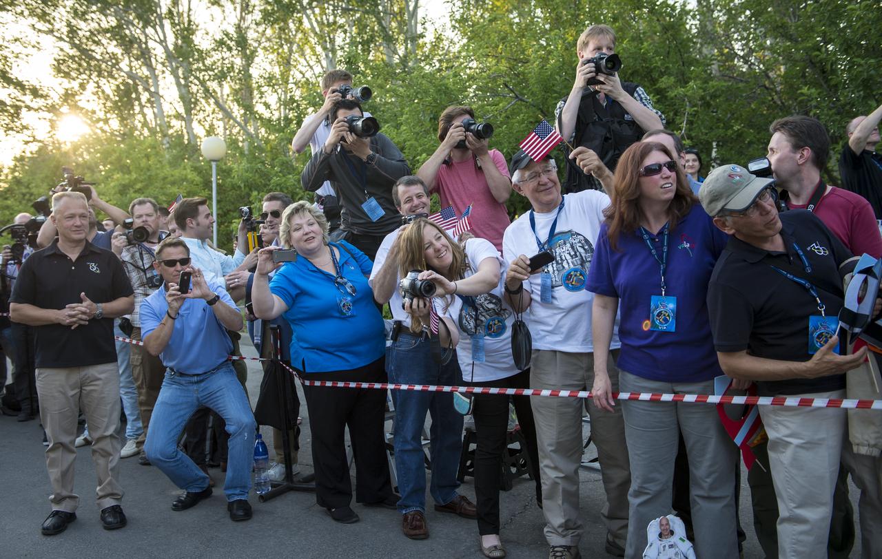 Family, friends, colleagues, and members of the media, watch and photograph Expedition 36/37 Soyuz Commander Fyodor Yurchikhin of the Russian Federal Space Agency (Roscosmos), Flight Engineers; Karen Nyberg of NASA, and Luca Parmitano of the European Space Agency as they depart the Cosmonaut Hotel, Tuesday, May 28, 2013, in Baikonur, Kazakhstan. Yurichikin, Nyberg, Parmitano were departing the hotel in preparation for their launch on a Soyuz rocket to the International Space Station (ISS) on Wednesday May 29, Kazakh time. Photo credit: (NASA/Bill Ingalls)