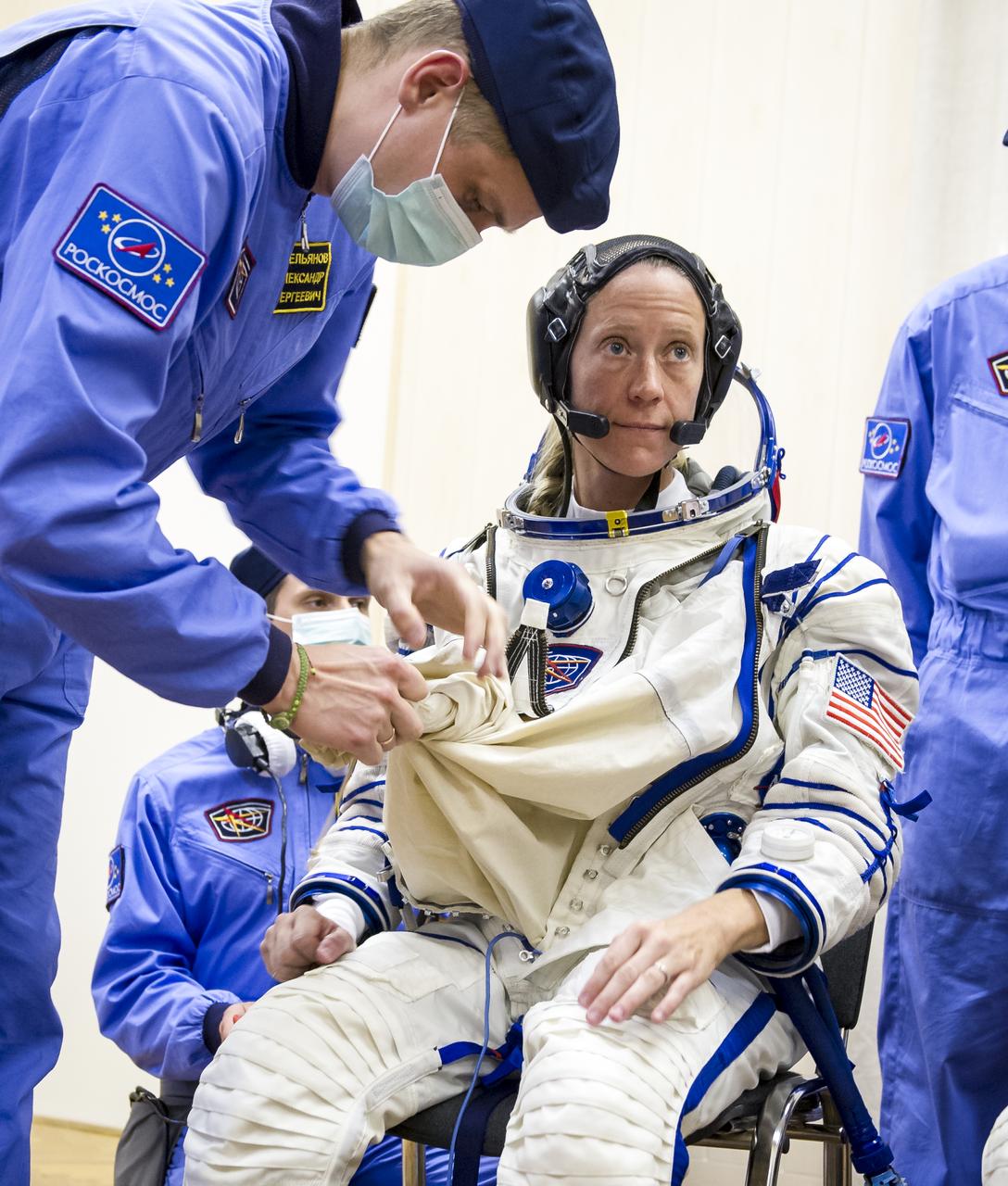 Expedition 36 NASA Flight Engineer Karen Nyberg is helped into her Russian Sokol suit as she and fellow crewmates, Soyuz Commander Fyodor Yurchikhin and European Space Agency Flight Engineer Luca Parmitano prepare for their Soyuz launch to the International Space Station, Tuesday, May 28, 2013, in Baikonur, Kazakhstan. Launch of the Soyuz rocket will send Nyberg, Yurchikhin and Parmitano on a five and a half month mission aboard the International Space Station.  Photo Credit: (NASA/GCTC/Andrey Shelepin)