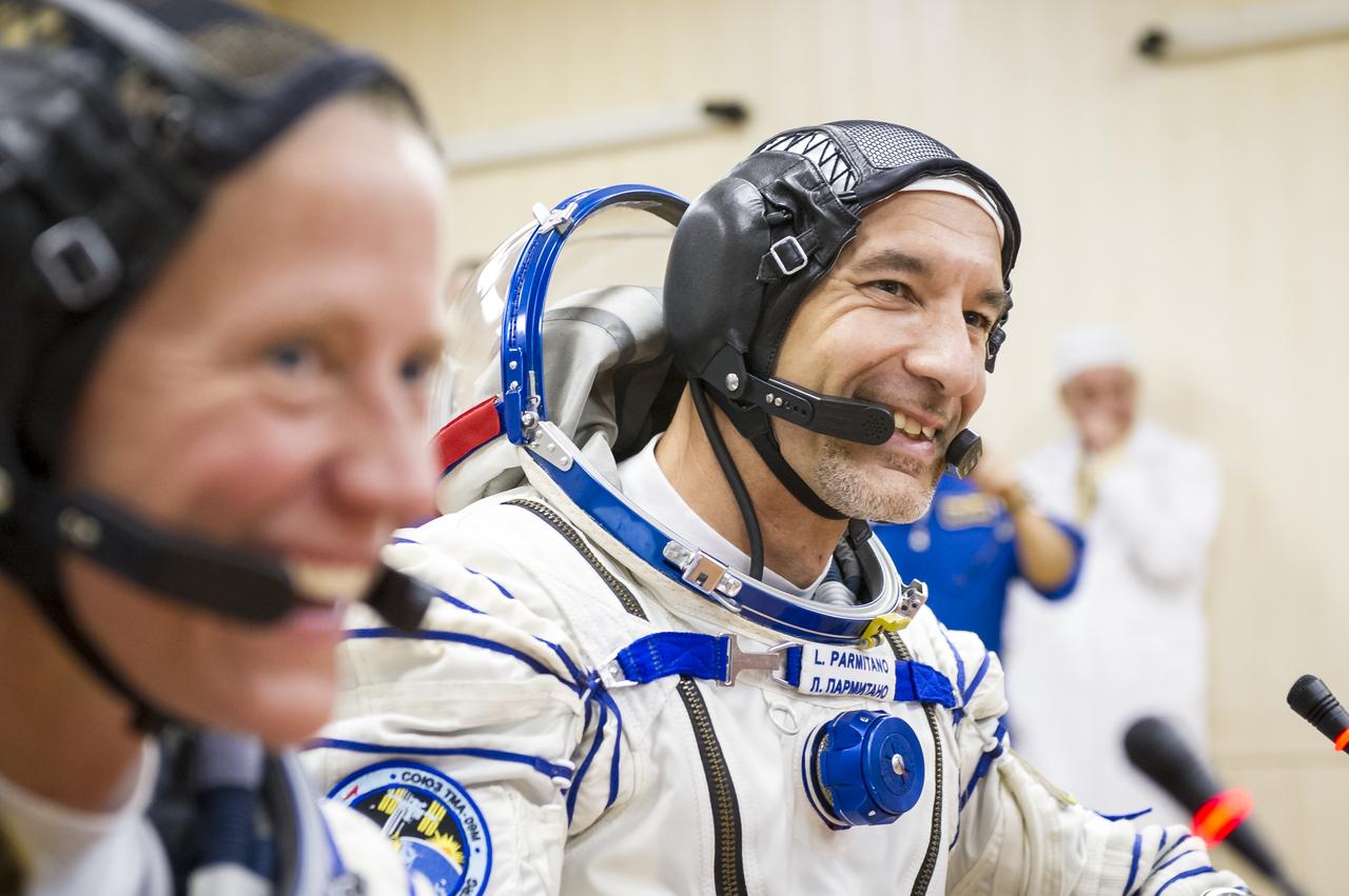 Expedition 36 European Space Agency Flight Engineer Luca Parmitano is seen talking to family members after donning his Russian Sokol suit in preparation for his launch aboard the Soyuz rocket, Tuesday, May 28, 2013, at the Baikonur Cosmodrome in Kazakhstan. Launch of the Soyuz rocket will send Parmitano, Soyuz Commander Fyodor Yurchikhin and Flight Engineer Karen Nyberg on a five and a half-month mission aboard the International Space Station. Photo Credit: (NASA/GCTC/Andrey Shelepin)