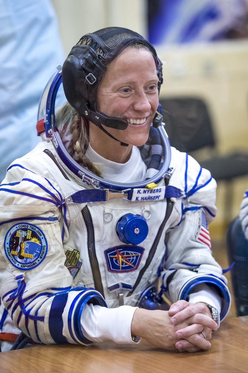 Expedition 36 NASA Flight Engineer Karen Nyberg is seen talking to family members after donning her Russian Sokol suit in preparation for her launch aboard the Soyuz rocket, Tuesday, May 28, 2013, at the Baikonur Cosmodrome in Kazakhstan.  Launch of the Soyuz rocket will send Nyberg, Soyuz Commander Fyodor Yurchikhin and European Space Agency Flight Engineer Luca Parmitano on a five and a half-month mission aboard the International Space Station.  Photo Credit: (NASA/Bill Ingalls)