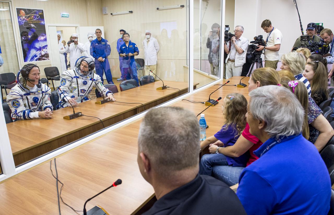 Expedition 36 NASA Flight Engineer Karen Nyberg ,left, and European Space Agency astronaut Luca Parmitano are seen talking to family members after donning their Russian Sokol suits in preparation for their launch aboard the Soyuz rocket, Tuesday, May 28, 2013, at the Baikonur Cosmodrome in Kazakhstan. Launch of the Soyuz rocket will send Nyberg, Parmitano and Soyuz Commander Fyodor Yurchikhin on a five and a half-month mission aboard the International Space Station. Photo Credit: (NASA/Bill Ingalls)