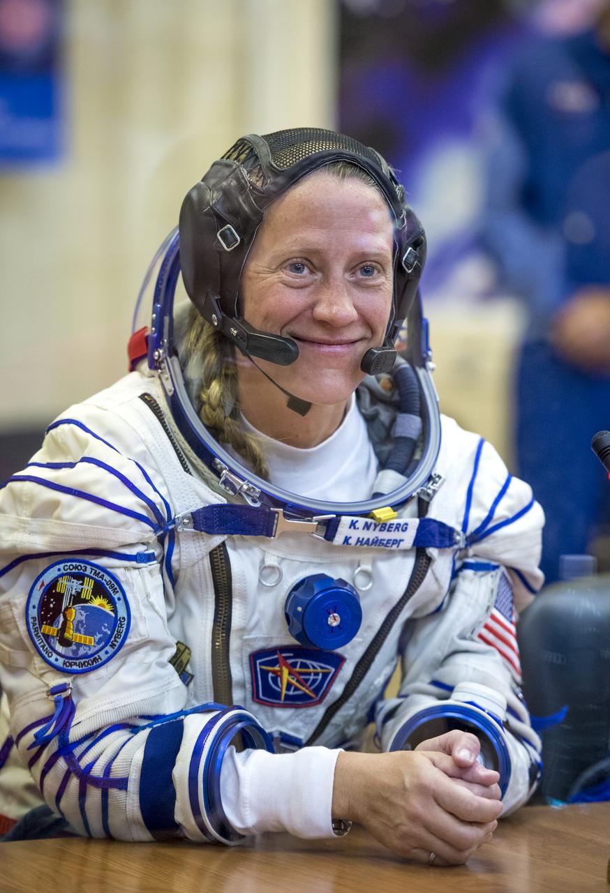 Expedition 36 NASA Flight Engineer Karen Nyberg is seen talking to family members after donning her Russian Sokol suit in preparation for her launch aboard the Soyuz rocket, Tuesday, May 28, 2013, at the Baikonur Cosmodrome in Kazakhstan.  Launch of the Soyuz rocket will send Nyberg, Soyuz Commander Fyodor Yurchikhin and European Space Agency Flight Engineer Luca Parmitano on a five and a half-month mission aboard the International Space Station.  Photo Credit: (NASA/Bill Ingalls)