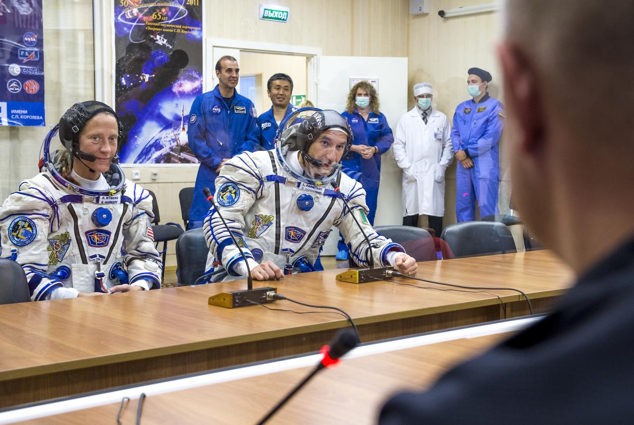 Expedition 36 European Space Agency Flight Engineer Luca Parmitano, right, is seen talking to family members after donning his Russian Sokol suit in preparation for his launch aboard the Soyuz rocket, Tuesday, May 28, 2013, at the Baikonur Cosmodrome in Kazakhstan. Launch of the Soyuz rocket will send Parmitano, Soyuz Commander Fyodor Yurchikhin and Flight Engineer Karen Nyberg on a five and a half-month mission aboard the International Space Station. Photo Credit: (NASA/Bill Ingalls)