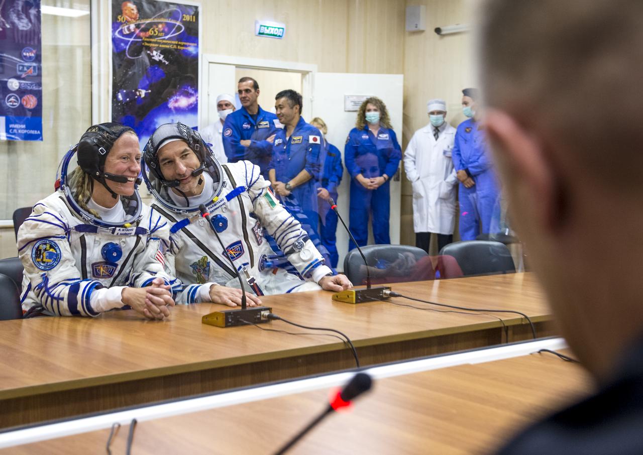 Expedition 36 NASA Flight Engineer Karen Nyberg,left, and European Space Agency astronaut Luca Parmitano are seen talking to family members after donning their Russian Sokol suits in preparation for their launch aboard the Soyuz rocket, Tuesday, May 28, 2013, at the Baikonur Cosmodrome in Kazakhstan.  Launch of the Soyuz rocket will send Nyberg, Parmitano and Soyuz Commander Fyodor Yurchikhin on a five and a half-month mission aboard the International Space Station.  Photo Credit: (NASA/Bill Ingalls)