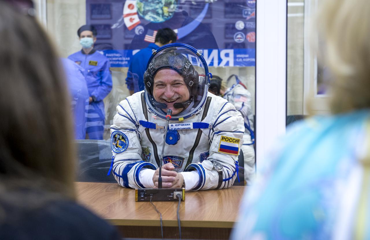 Expedition 36 Soyuz Commander Fyodor Yurchikhin is seen talking to family members after donning his Russian Sokol suit in preparation for his launch aboard the Soyuz rocket, Tuesday, May 28, 2013, at the Baikonur Cosmodrome in Kazakhstan.  Launch of the Soyuz rocket will send Yurchikhin, Flight Engineer Karen Nyberg and European Space Agency Flight Engineer Luca Parmitano on a five and a half-month mission aboard the International Space Station.  Photo Credit: (NASA/Bill Ingalls)