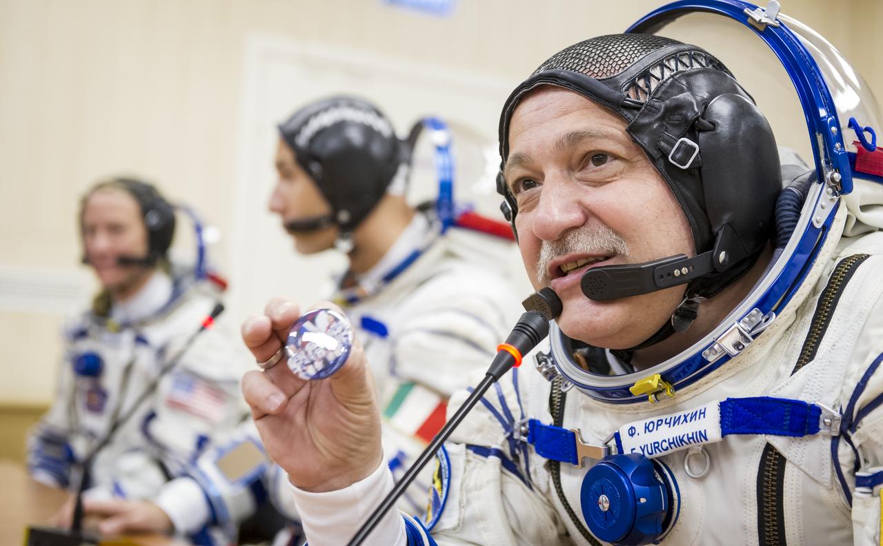 Expedition 36 Soyuz Commander Fyodor Yurchikhin is seen talking to family members after donning his Russian Sokol suit in preparation for his launch aboard the Soyuz rocket, Tuesday, May 28, 2013, at the Baikonur Cosmodrome in Kazakhstan.  Launch of the Soyuz rocket will send Yurchikhin, Flight Engineer Karen Nyberg and European Space Agency Flight Engineer Luca Parmitano on a five and a half-month mission aboard the International Space Station.  Photo Credit: (NASA/GCTC/Andrey Shelepin)