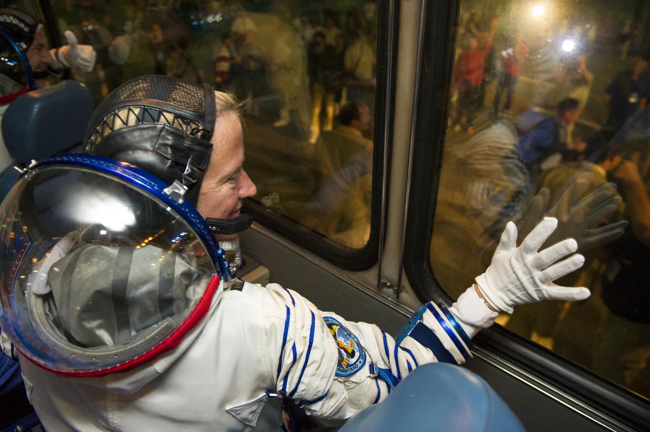 Expedition 36 NASA Flight Engineer Karen Nyberg is seen waving goodbye to friends and family after boarding the bus that will take her to the Soyuz launch pad hours ahead of her launch, Tuesday, May 28, 2013 at the Baikonur Cosmodrome in Kazakhstan.  Launch of the Soyuz rocket will send Nyberg, Soyuz Commander Fyodor Yurchikhin and European Space Agency Flight Engineer Luca Parmitano on a five and a half-month mission aboard the International Space Station.  Photo Credit: (NASA/GCTC/Andrey Shelepin)