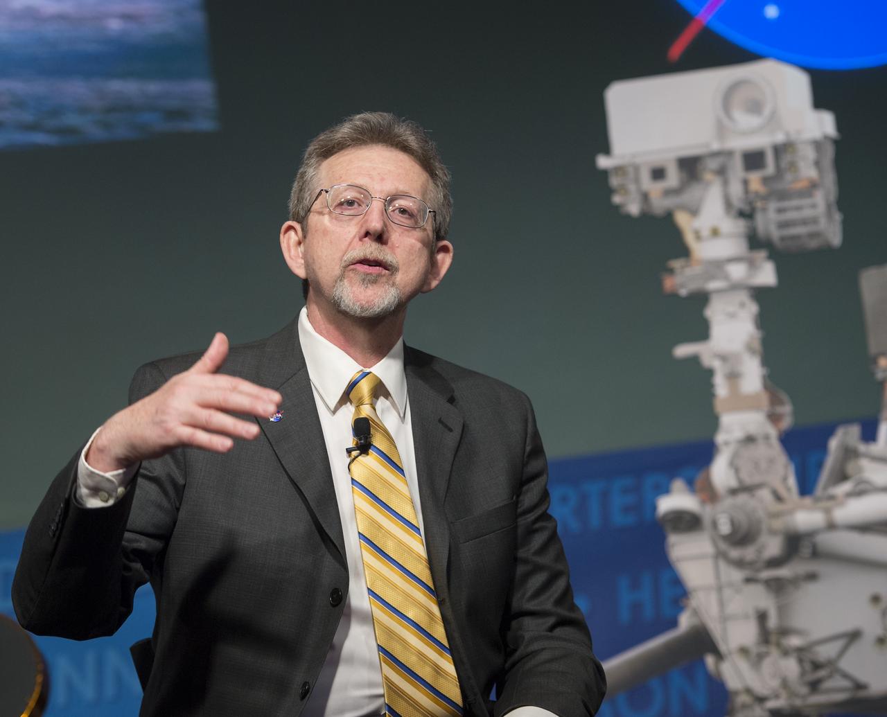 Jim Green, director, Planetary Division, NASA's Science Mission Directorate, speaks at a public event at NASA Headquarters observing the first anniversary of the Curiosity rover's landing on Mars, Tuesday, August 6th, 2013 in Washington.  The Mars Science Laboratory mission successfully placed the one-ton Curiosity rover on the surface of Mars on Aug. 6, 2012, about 1 mile from the center of its 12-mile-long target area.  Within the first eight months of a planned 23-months primary mission, Curiosity met its major science objective of finding evidence of a past environment well-suited to support microbial life.  Photo Credit: (NASA/Carla Cioffi)