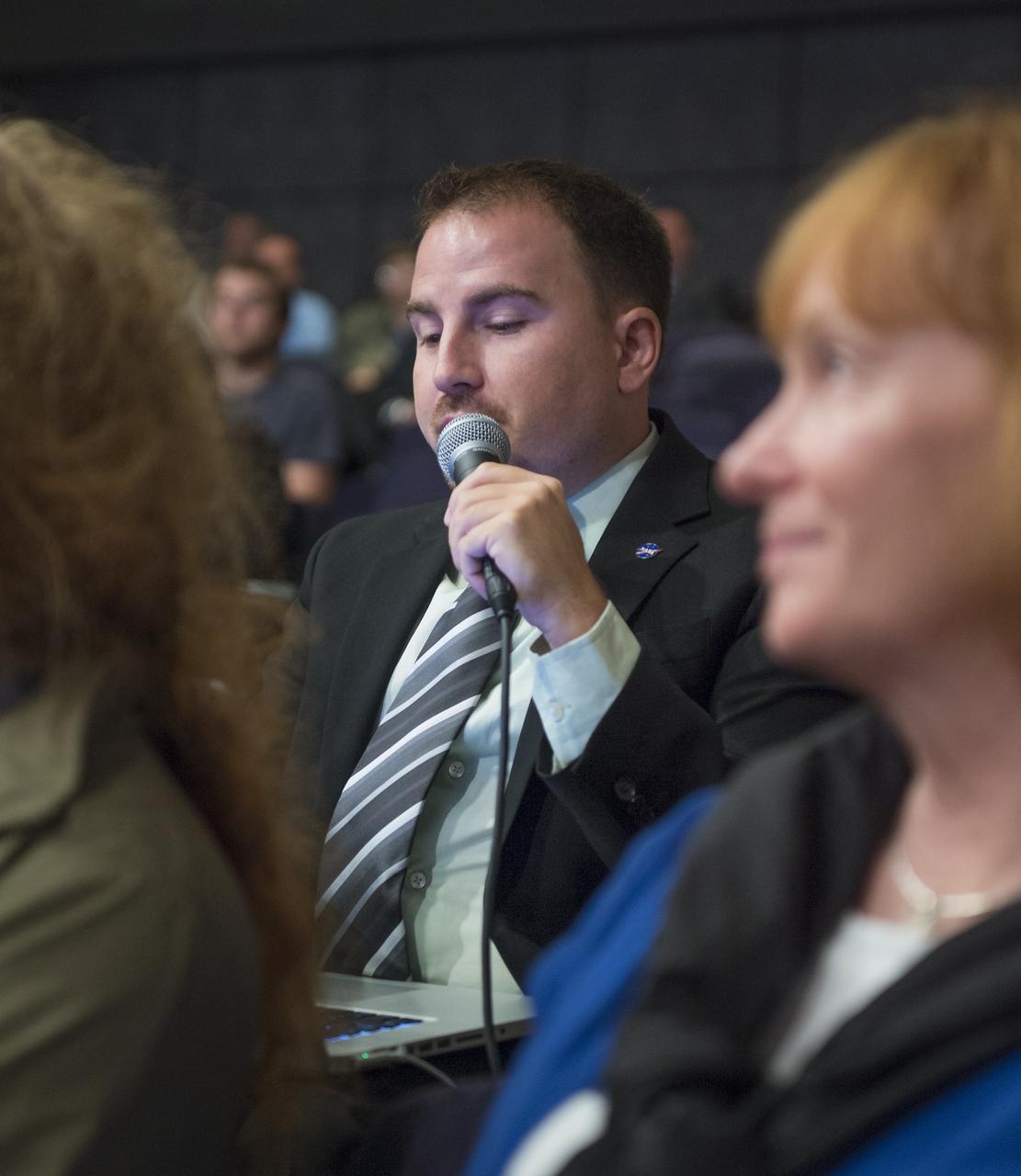 Jason Townsend, NASA's Deputy Social Media Manager, asks a question on behalf of a NASA Twitter follower at a public event at NASA Headquarters observing the first anniversary of the Curiosity rover's landing on Mars, Tuesday, August 6th, 2013 in Washington. The Mars Science Laboratory mission successfully placed the one-ton Curiosity rover on the surface of Mars on Aug. 6, 2012, about 1 mile from the center of its 12-mile-long target area. Within the first eight months of a planned 23-months primary mission, Curiosity met its major science objective of finding evidence of a past environment well-suited to support microbial life. Photo Credit: (NASA/Carla Cioffi)