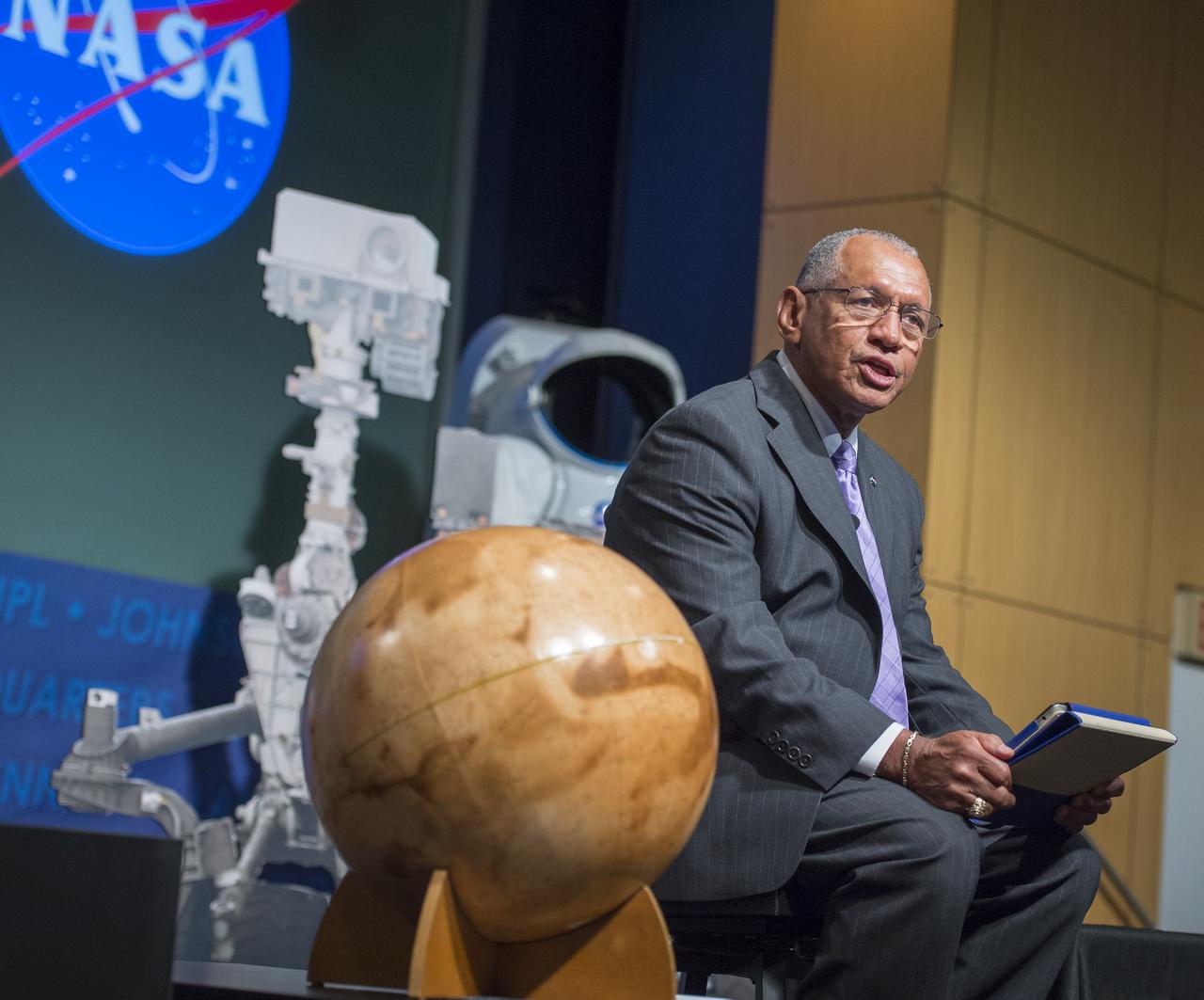 NASA Administrator Charles Bolden speaks at a public event at NASA Headquarters observing the first anniversary of the Curiosity rover's landing on Mars, Tuesday, August 6th, 2013 in Washington. The Mars Science Laboratory mission successfully placed the one-ton Curiosity rover on the surface of Mars on Aug. 6, 2012, about 1 mile from the center of its 12-mile-long target area. Within the first eight months of a planned 23-months primary mission, Curiosity met its major science objective of finding evidence of a past environment well-suited to support microbial life. Photo Credit: (NASA/Carla Cioffi)