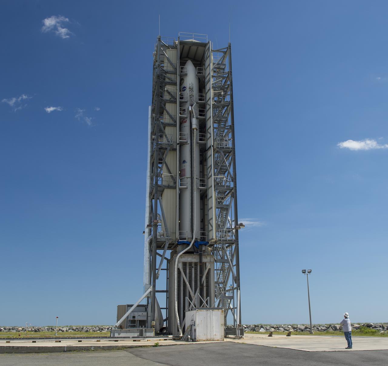 The doors of the gantry support structure are opened to reveal the Minotaur V rocket on Pad 0B at the Mid-Atlantic Regional Spaceport (MARS) at NASA's Wallops Flight Facility, Friday, Sept. 6, 2013 in Virginia.  The Minotaur V will launch NASA's Lunar Atmosphere and Dust Environment Explorer (LADEE).  LADEE is a robotic mission that will orbit the moon where it will provide unprecedented information about the environment around the moon and give scientists a better understanding of other planetary bodies in our solar system and beyond.  LADEE is scheduled to launch at 11:27 p.m. Friday, Sept. 6, from NASA's Wallops Flight Facility.  Photo Credit: (NASA/Carla Cioffi)