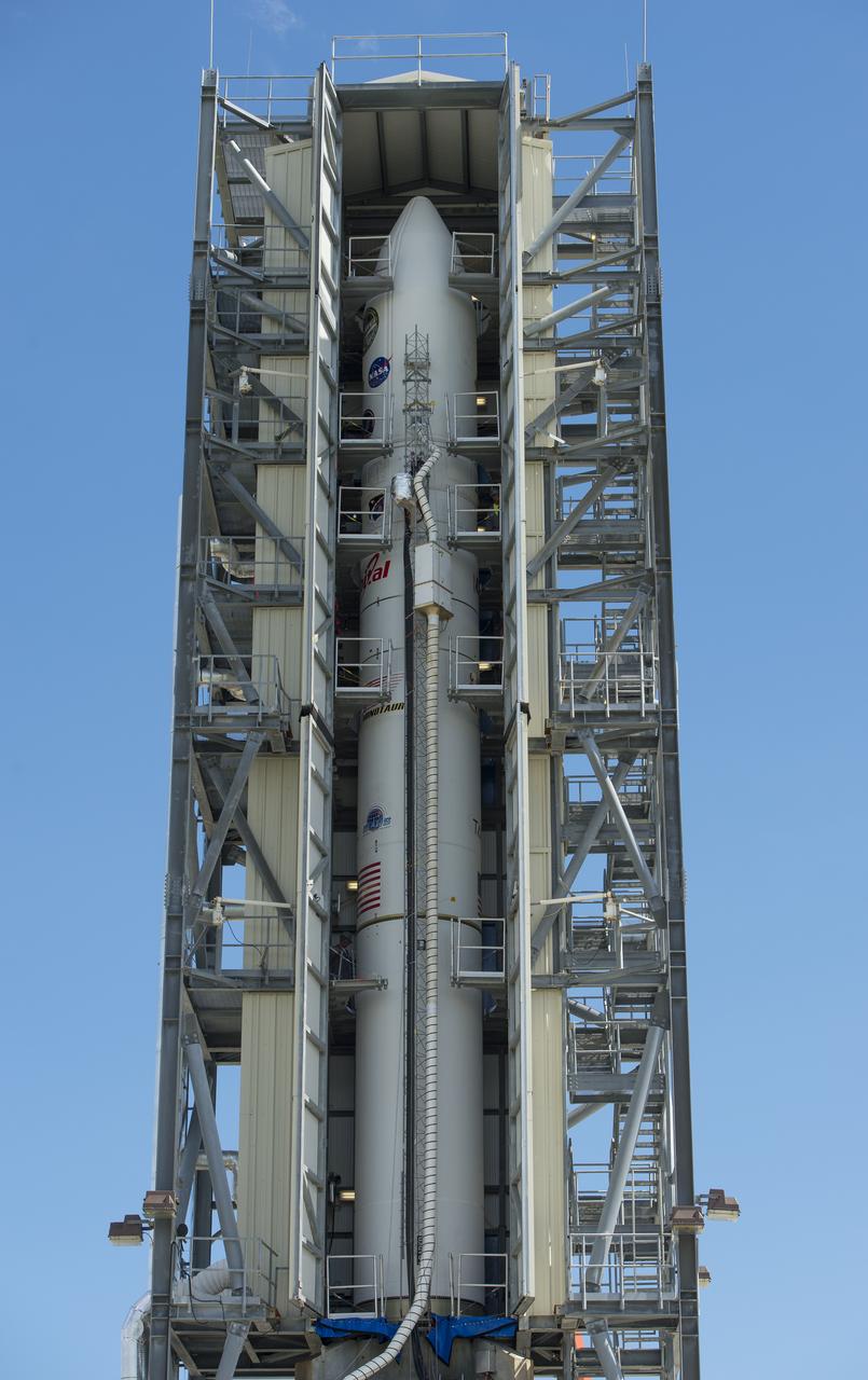 The doors of the gantry support structure are opened to reveal the Minotaur V rocket on Pad 0B at the Mid-Atlantic Regional Spaceport (MARS) at NASA's Wallops Flight Facility, Friday, Sept. 6, 2013 in Virginia.  The Minotaur V will launch NASA's Lunar Atmosphere and Dust Environment Explorer (LADEE).  LADEE is a robotic mission that will orbit the moon where it will provide unprecedented information about the environment around the moon and give scientists a better understanding of other planetary bodies in our solar system and beyond.  LADEE is scheduled to launch at 11:27 p.m. Friday, Sept. 6, from NASA's Wallops Flight Facility.  Photo Credit: (NASA/Carla Cioffi)