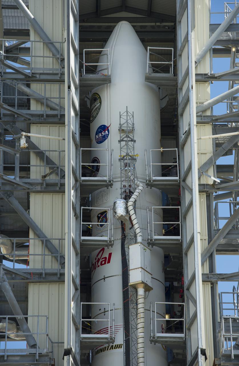 The doors of the gantry support structure are opened to reveal the Minotaur V rocket on Pad 0B at the Mid-Atlantic Regional Spaceport (MARS) at NASA's Wallops Flight Facility, Friday, Sept. 6, 2013 in Virginia.  The Minotaur V will launch NASA's Lunar Atmosphere and Dust Environment Explorer (LADEE).  LADEE is a robotic mission that will orbit the moon where it will provide unprecedented information about the environment around the moon and give scientists a better understanding of other planetary bodies in our solar system and beyond.  LADEE is scheduled to launch at 11:27 p.m. Friday, Sept. 6, from NASA's Wallops Flight Facility.  Photo Credit: (NASA/Carla Cioffi)