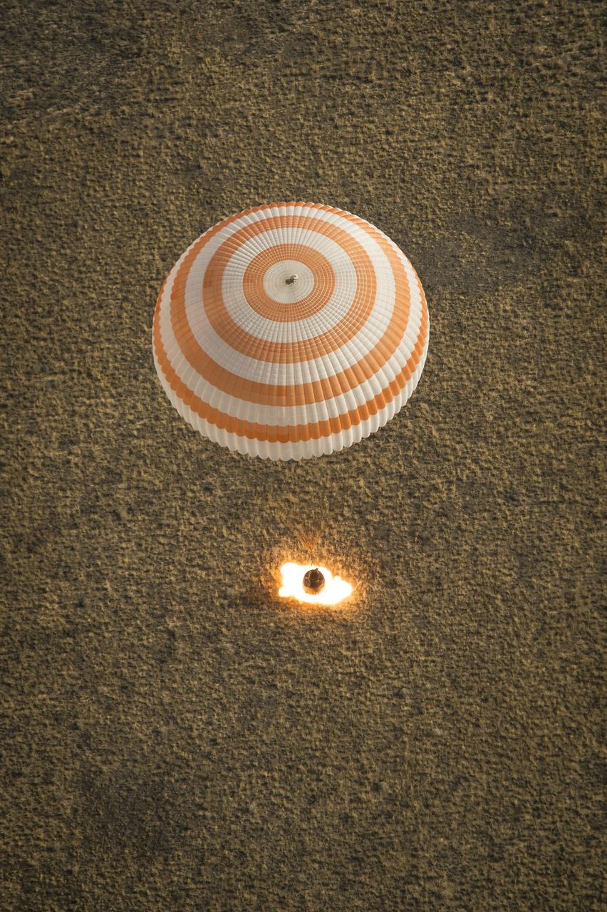 The Soyuz TMA-08M spacecraft with Expedition 36 Commander Pavel Vinogradov of the Russian Federal Space Agency (Roscosmos), Flight Engineer Alexander Misurkin of Roscosmos and Flight Engineer Chris Cassidy of NASA aboard, is seen as it lands in a remote area near the town of Zhezkazgan, Kazakhstan, on Wednesday, Sept. 11, 2013. Vinogradov, Misurkin and Cassidy returned to Earth after five and a half months on the International Space Station. Photo Credit: (NASA/Bill Ingalls)