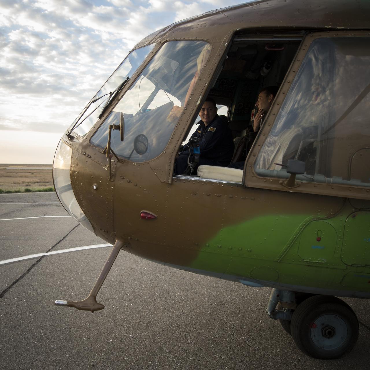 A Russian search and rescue helicopter and crew wait to depart the Zhezkazgan airport in Kazakhstan to support the landing of the Soyuz TMA-08M spacecraft with Expedition 36 Commander Pavel Vinogradov of the Russian Federal Space Agency (Roscosmos), Flight Engineer Alexander Misurkin of Roscosmos and Flight Engineer Chris Cassidy, Wednesday, Sept. 11, 2013. Vinogradov, Misurkin and Cassidy are returning to Earth after five and a half months on the International Space Station. Photo Credit: (NASA/Bill Ingalls)