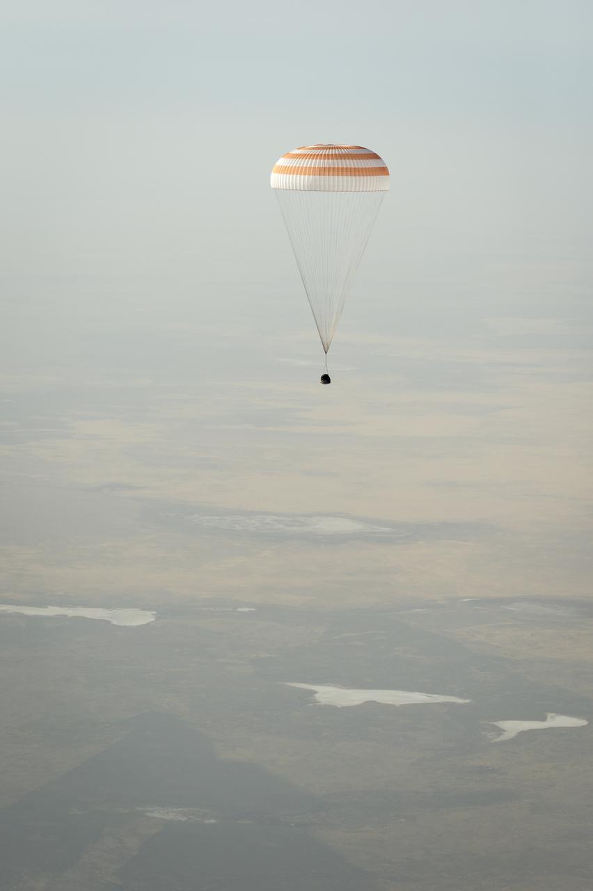 The Soyuz TMA-08M spacecraft with Expedition 36 Commander Pavel Vinogradov of the Russian Federal Space Agency (Roscosmos), Flight Engineer Alexander Misurkin of Roscosmos and Flight Engineer Chris Cassidy of NASA aboard, is seen as it lands in a remote area near the town of Zhezkazgan, Kazakhstan, on Wednesday, Sept. 11, 2013. Vinogradov, Misurkin and Cassidy returned to Earth after five and a half months on the International Space Station. Photo Credit: (NASA/Bill Ingalls)