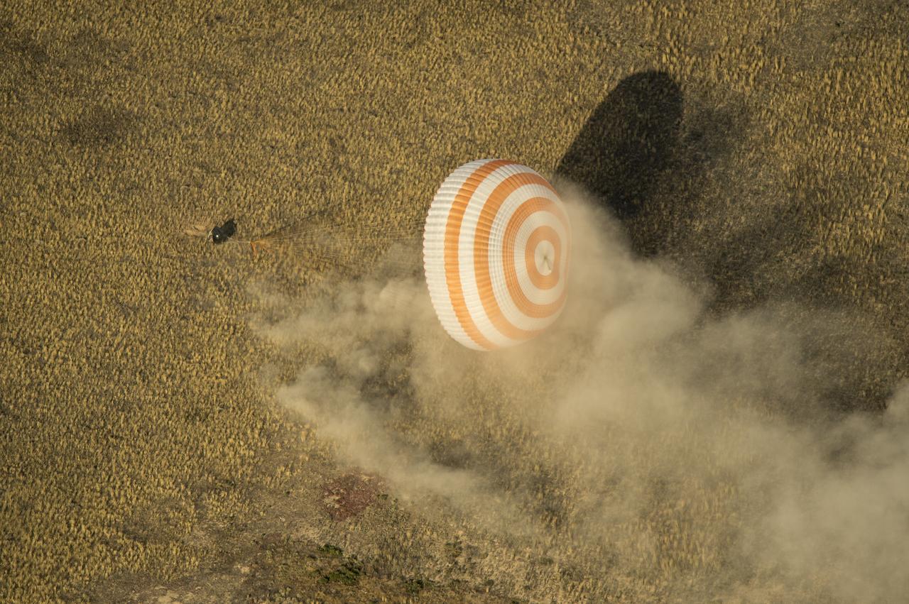 The Soyuz TMA-08M spacecraft with Expedition 36 Commander Pavel Vinogradov of the Russian Federal Space Agency (Roscosmos), Flight Engineer Alexander Misurkin of Roscosmos and Flight Engineer Chris Cassidy of NASA aboard, is seen as it lands in a remote area near the town of Zhezkazgan, Kazakhstan, on Wednesday, Sept. 11, 2013. Vinogradov, Misurkin and Cassidy returned to Earth after five and a half months on the International Space Station. Photo Credit: (NASA/Bill Ingalls)