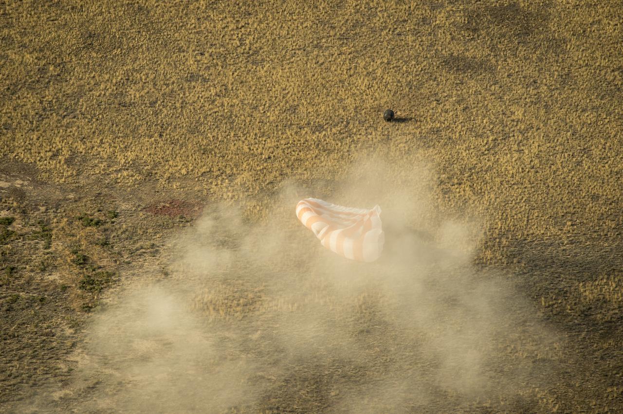 The Soyuz TMA-08M spacecraft with Expedition 36 Commander Pavel Vinogradov of the Russian Federal Space Agency (Roscosmos), Flight Engineer Alexander Misurkin of Roscosmos and Flight Engineer Chris Cassidy of NASA aboard, is seen as it lands in a remote area near the town of Zhezkazgan, Kazakhstan, on Wednesday, Sept. 11, 2013. Vinogradov, Misurkin and Cassidy returned to Earth after five and a half months on the International Space Station. Photo Credit: (NASA/Bill Ingalls)
