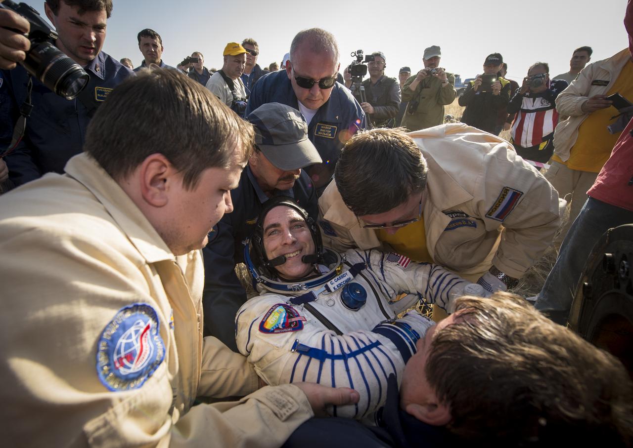 Expedition 36 Flight Engineer Chris Cassidy of NASA is helped out of the Soyuz TMA-08M capsule after he and, Commander Pavel Vinogradov of Russian Federal Space Agency (Roscosmos), and Flight Engineer Alexander Misurkin of Roscosmos landed in a Soyuz TMA-08M spacecraft in a remote area near the town of Zhezkazgan, Kazakhstan, on Wednesday, Sept. 11, 2013. Vinogradov, Misurkin and Cassidy returned to Earth after five and a half months on the International Space Station. Photo Credit: (NASA/Bill Ingalls)