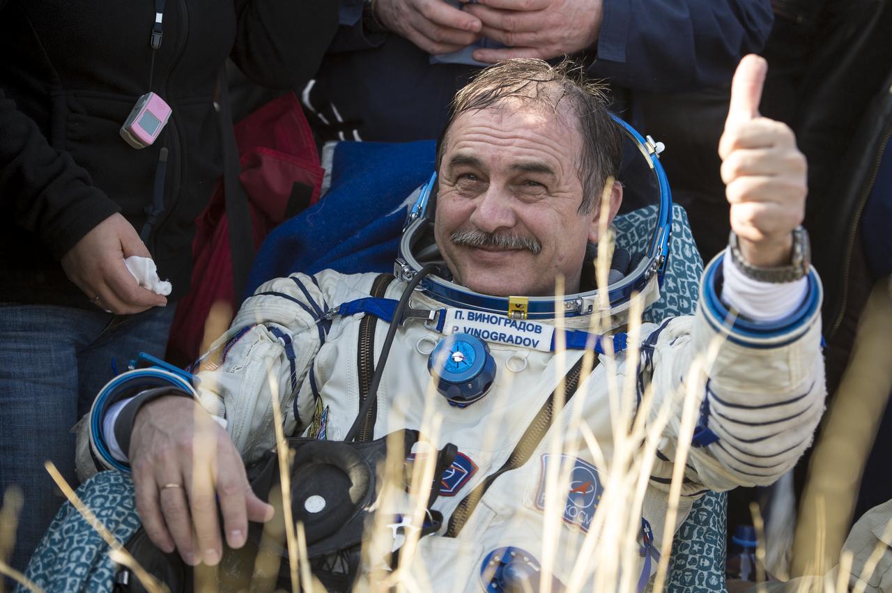 Expedition 36 Commander Pavel Vinogradov of the Russian Federal Space Agency (Roscosmos) smiles and gives a thumbs up after he and, Flight Engineer Alexander Misurkin of Roscosmos and Flight Engineer Chris Cassidy of NASA landed their Soyuz TMA-08M spacecraft in a remote area near the town of Zhezkazgan, Kazakhstan, on Wednesday, Sept. 11, 2013. Vinogradov, Misurkin and Cassidy returned to Earth after five and a half months on the International Space Station. Photo Credit: (NASA/Bill Ingalls)