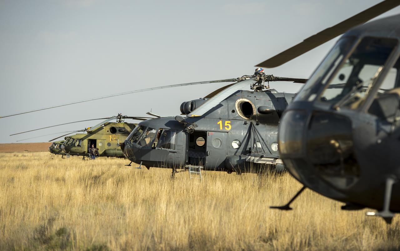 Russian search and rescue MI-8 helicopters are seen at the landing site of the Soyuz TMA-08M spacecraft in a remote area near the town of Zhezkazgan, Kazakhstan, on Wednesday, Sept. 11, 2013. The Soyuz landed with Expedition 36 Commander Pavel Vinogradov of the Russian Federal Space Agency (Roscosmos), Flight Engineer Alexander Misurkin of Roscosmos and Flight Engineer Chris Cassidy. Vinogradov, Misurkin and Cassidy are returning to Earth after five and a half months on the International Space Station. Photo Credit: (NASA/Bill Ingalls)