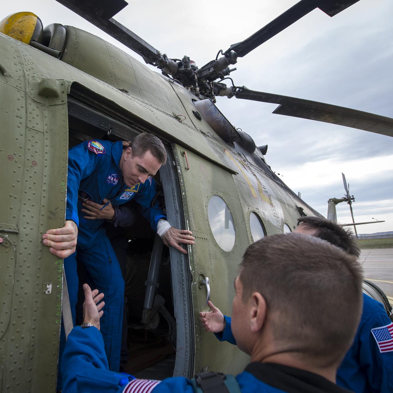 Expedition 36 Flight Engineer Chris Cassidy of NASA is helped out of a helicopter at the Karaganda airport in Kazakhstan after having been flown from the Soyuz TMA-08M spacecraft landing site in a remote area near the town of Zhezkazgan, Wednesday, Sept. 11, 2013. Cassidy, Commander Pavel Vinogradov of Russian Federal Space Agency (Roscosmos), and Flight Engineer Alexander Misurkin of Roscosmos returned to Earth after five and a half months on the International Space Station. Photo Credit: (NASA/Bill Ingalls)