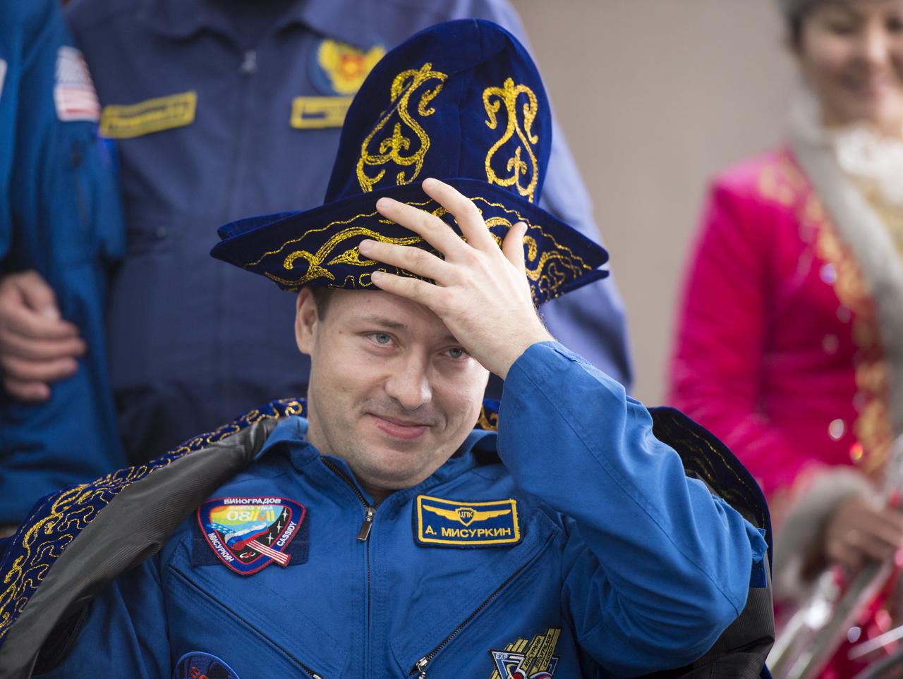 Expedition 36 Flight Engineer Alexander Misurkin of the Russian Federal Space Agency (Roscosmos) adjust a traditional Kazakh hat given to him during a ceremony at the Karaganda airport in Kazakhstan after having been flown from the Soyuz TMA-08M spacecraft landing site in a remote area near the town of Zhezkazgan, Wednesday, Sept. 11, 2013. Misurkin, Commander Pavel Vinogradov of Roscosmos, and Flight Engineer Chris Cassidy of NASA returned to Earth after five and a half months on the International Space Station. Photo Credit: (NASA/Bill Ingalls)