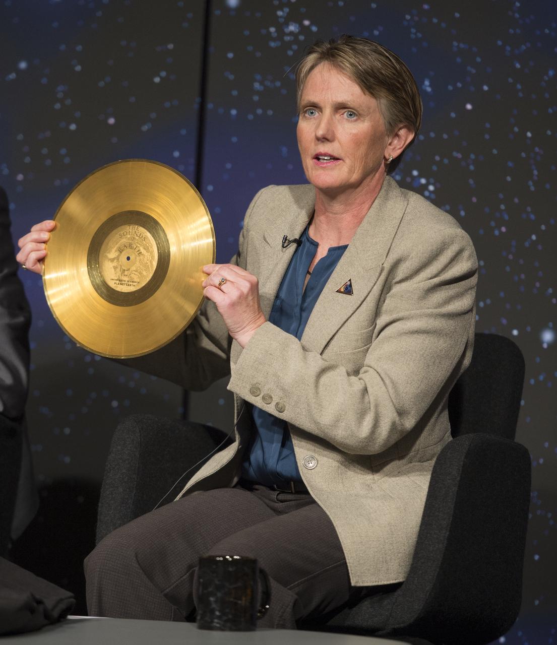 Suzanne Dodd, Voyager project manager, NASA's Jet Propulsion Lab (JPL) holds a replica of the golden record carried on Voyager at a news conference on NASA's Voyager 1 spacecraft, Thursday, Sept. 12, 2013 at NASA Headquarters in Washington.  The Golden Record was intended to communicate a story of our world to extraterrestrials.  NASA's Voyager 1 spacecraft officially is the first human-made object to venture into interstellar space. The 36-year-old probe is about 12 billion miles (19 billion kilometers) from our sun.  New and unexpected data indicate Voyager 1 has been traveling for about one year through plasma, or ionized gas, present in the space between stars.  A report on the analysis of this new data is published in Thursday's edition of the journal Science.  Photo Credit:  (NASA/Carla Cioffi)