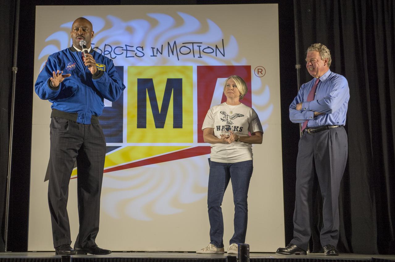 Leland Melvin, NASA Associate Administrator for Education and former 2x astronaut, Hardy Middle School Prinipal Patricia Pride, and Tom Buckmaster, President, Honeywell Hometown Solutions introduce "FMA Live!" at Hardy Middle School in Washington on Monday, Sept. 16th, 2013. "FMA Live!" is a program sponsored by NASA and Honeywell that teaches Newton's three laws of motion mixed with dance and music. The program travels across the country and has reached nearly 300,000 students.Photo Credit: (NASA/Jay Westcott)