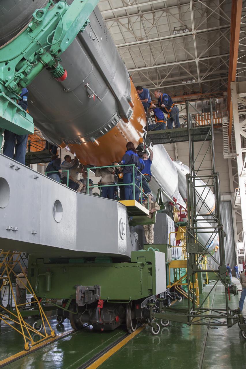 The Soyuz rocket and Soyuz TMA-10M spacecraft are assembled at Building 112 on the Baikonur Cosmodrome, on Sunday, Sept. 22, 2013 in Baikonur, Kazakhstan. Launch of the Soyuz rocket is scheduled for September 26 and will send Expedition 37 Soyuz Commander Oleg Kotov, NASA Flight Engineer Michael Hopkins and Russian Flight Engineer Sergei Ryazansky on a five and a half-month mission aboard the International Space Station. Photo Credit: (NASA/Victor Zelentsov)