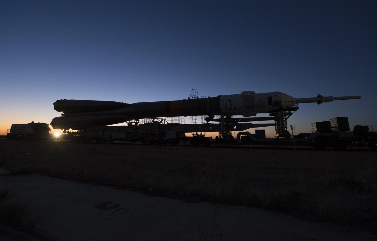 The Soyuz rocket is rolled out to the launch pad by train on Monday, Sept. 23, 2013, at the Baikonur Cosmodrome in Kazakhstan. Launch of the Soyuz rocket is scheduled for September 26 and will send Expedition 37 Soyuz Commander Oleg Kotov, NASA Flight Engineer Michael Hopkins and Russian Flight Engineer Sergei Ryazansky on a five and a half-month mission aboard the International Space Station.  Photo Credit: (NASA/Carla Cioffi)