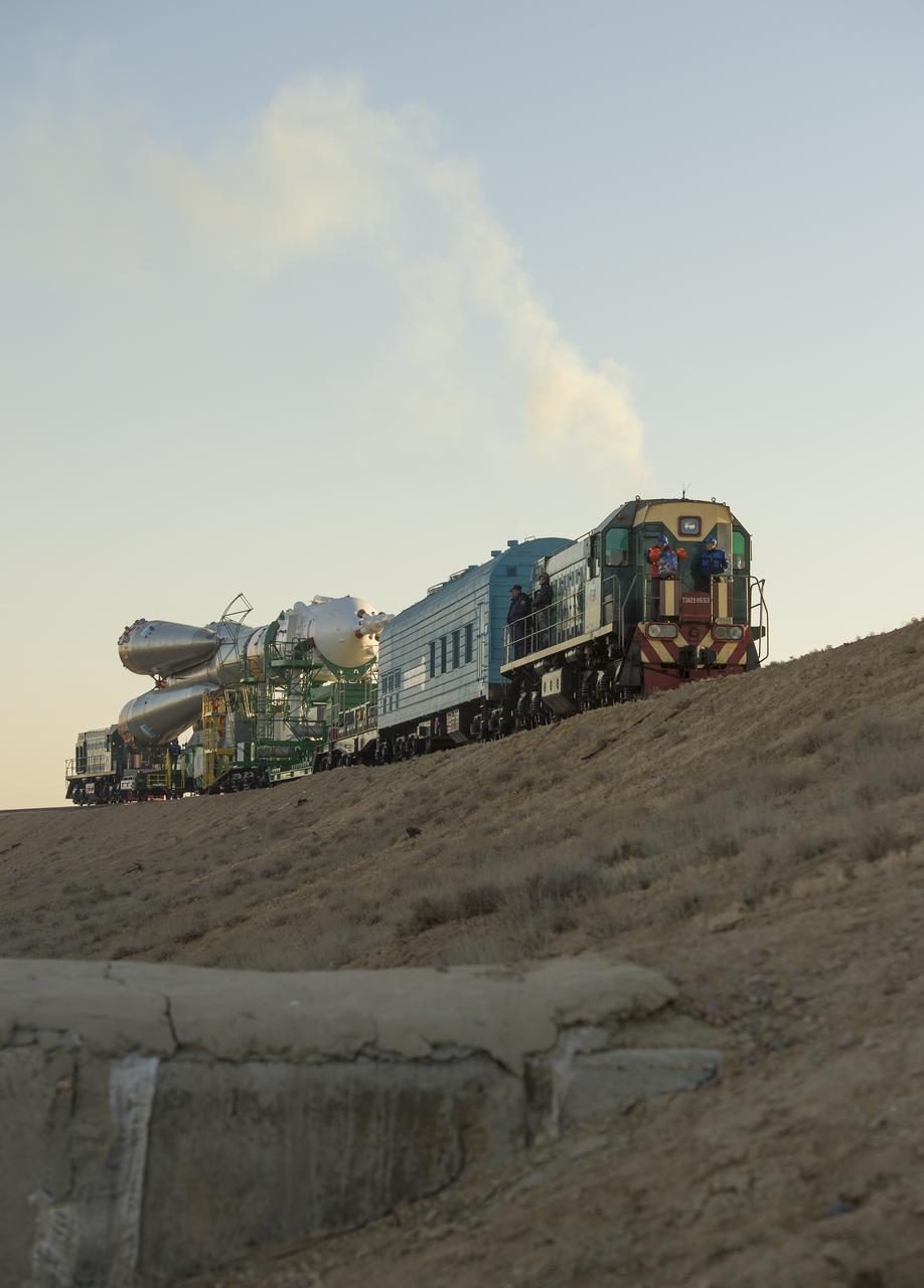 The Soyuz rocket is rolled out to the launch pad by train on Monday, Sept. 23, 2013, at the Baikonur Cosmodrome in Kazakhstan. Launch of the Soyuz rocket is scheduled for September 26 and will send Expedition 37 Soyuz Commander Oleg Kotov, NASA Flight Engineer Michael Hopkins and Russian Flight Engineer Sergei Ryazansky on a five and a half-month mission aboard the International Space Station.  Photo Credit: (NASA/Carla Cioffi)
