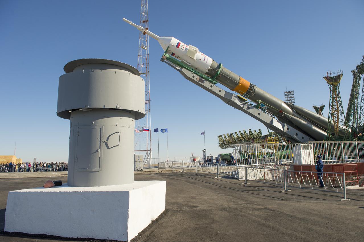 The Soyuz rocket is erected into position after being rolled out to the launch pad by train on Monday, Sept. 23, 2013, at the Baikonur Cosmodrome in Kazakhstan. Launch of the Soyuz rocket is scheduled for September 26 and will send Expedition 37 Soyuz Commander Oleg Kotov, NASA Flight Engineer Michael Hopkins and Russian Flight Engineer Sergei Ryazansky on a five and a half-month mission aboard the International Space Station.  Photo Credit: (NASA/Carla Cioffi)