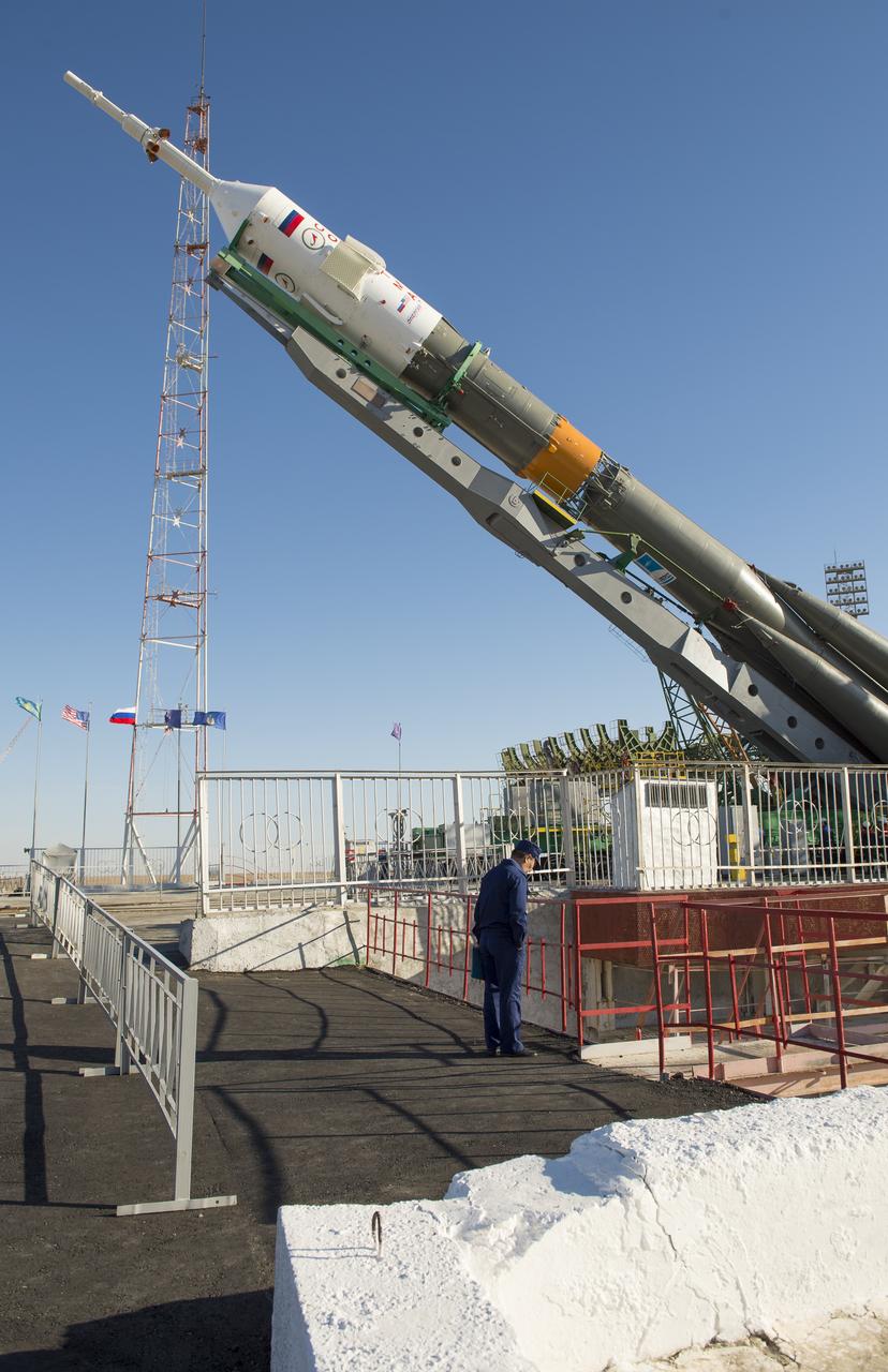 The Soyuz rocket is erected into position after being rolled out to the launch pad by train on Monday, Sept. 23, 2013, at the Baikonur Cosmodrome in Kazakhstan. Launch of the Soyuz rocket is scheduled for September 26 and will send Expedition 37 Soyuz Commander Oleg Kotov, NASA Flight Engineer Michael Hopkins and Russian Flight Engineer Sergei Ryazansky on a five and a half-month mission aboard the International Space Station.  Photo Credit: (NASA/Carla Cioffi)
