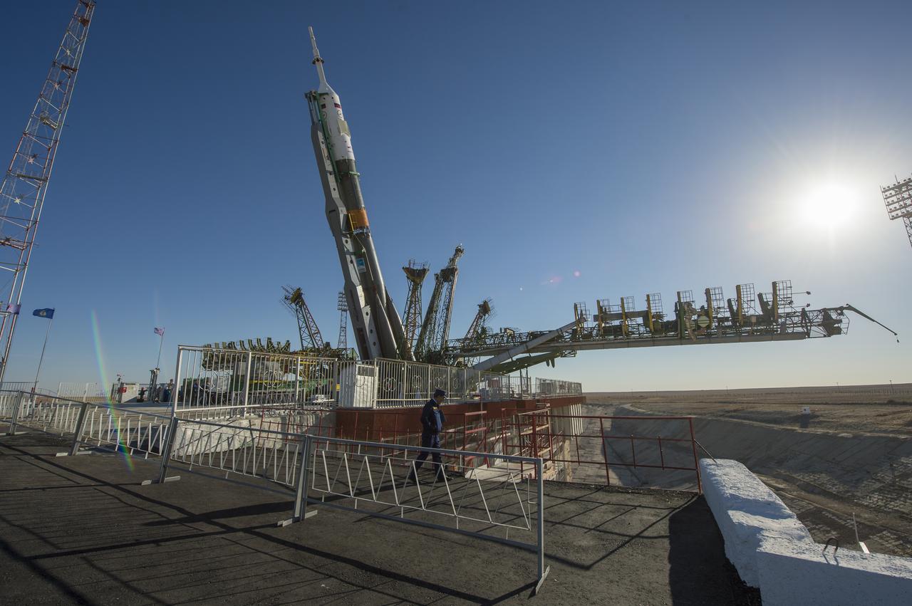 The Soyuz rocket is erected into position after being rolled out to the launch pad by train on Monday, Sept. 23, 2013, at the Baikonur Cosmodrome in Kazakhstan. Launch of the Soyuz rocket is scheduled for September 26 and will send Expedition 37 Soyuz Commander Oleg Kotov, NASA Flight Engineer Michael Hopkins and Russian Flight Engineer Sergei Ryazansky on a five and a half-month mission aboard the International Space Station.  Photo Credit: (NASA/Carla Cioffi)