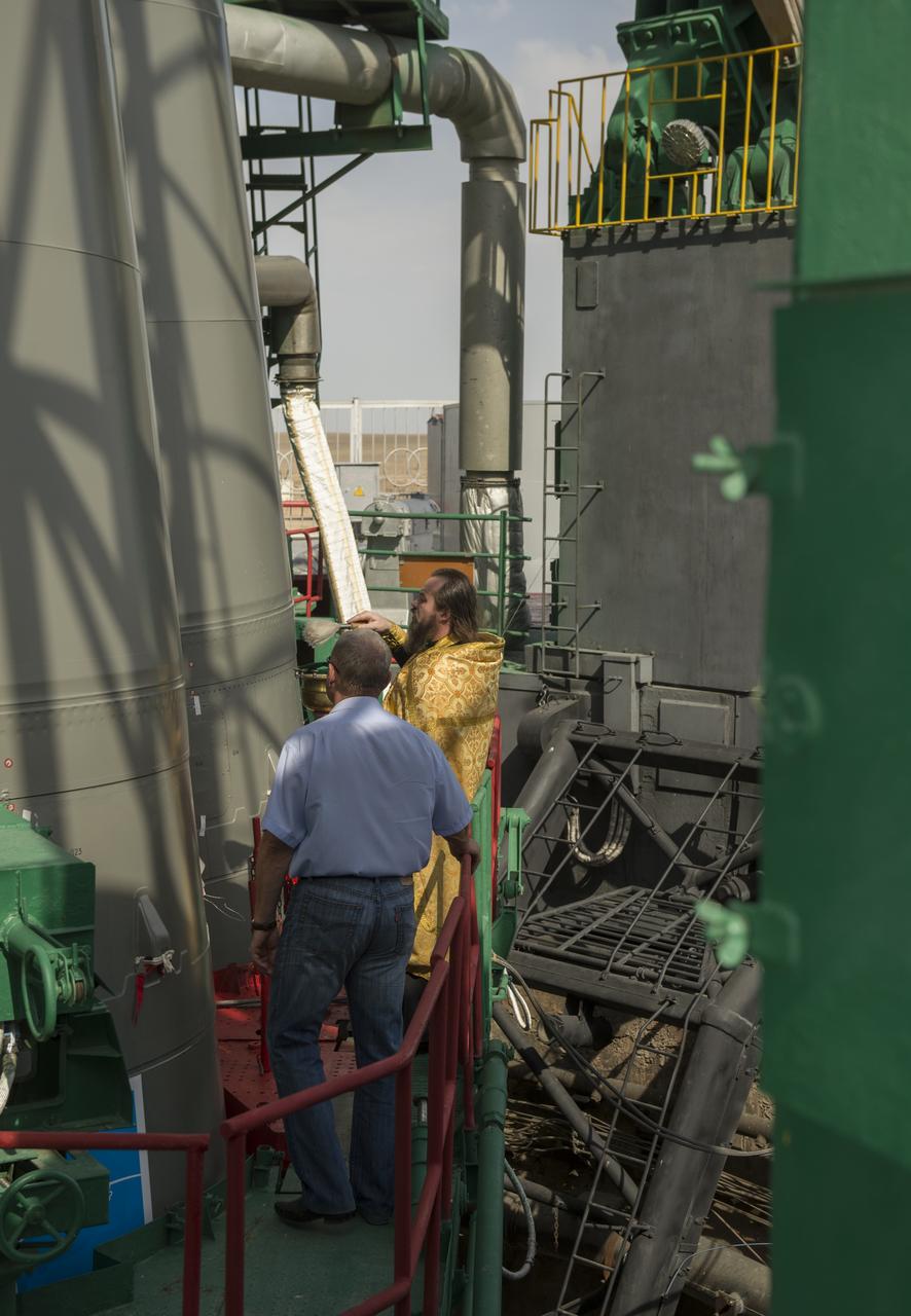 An Orthodox priest blesses the Soyuz rocket at the Baikonur Cosmodrome Launch pad on Tuesday, Sept. 24, 2013 in Baikonur, Kazakhstan. Launch of the Soyuz rocket is scheduled for September 26 and will send Expedition 37/38 Flight Engineer Michael Hopkins of NASA, Soyuz Commander Oleg Kotov and Flight Engineer and Russian Flight Engineer Sergei Ryazansky on a five-month mission aboard the International Space Station. Photo Credit: (NASA/Carla Cioffi)